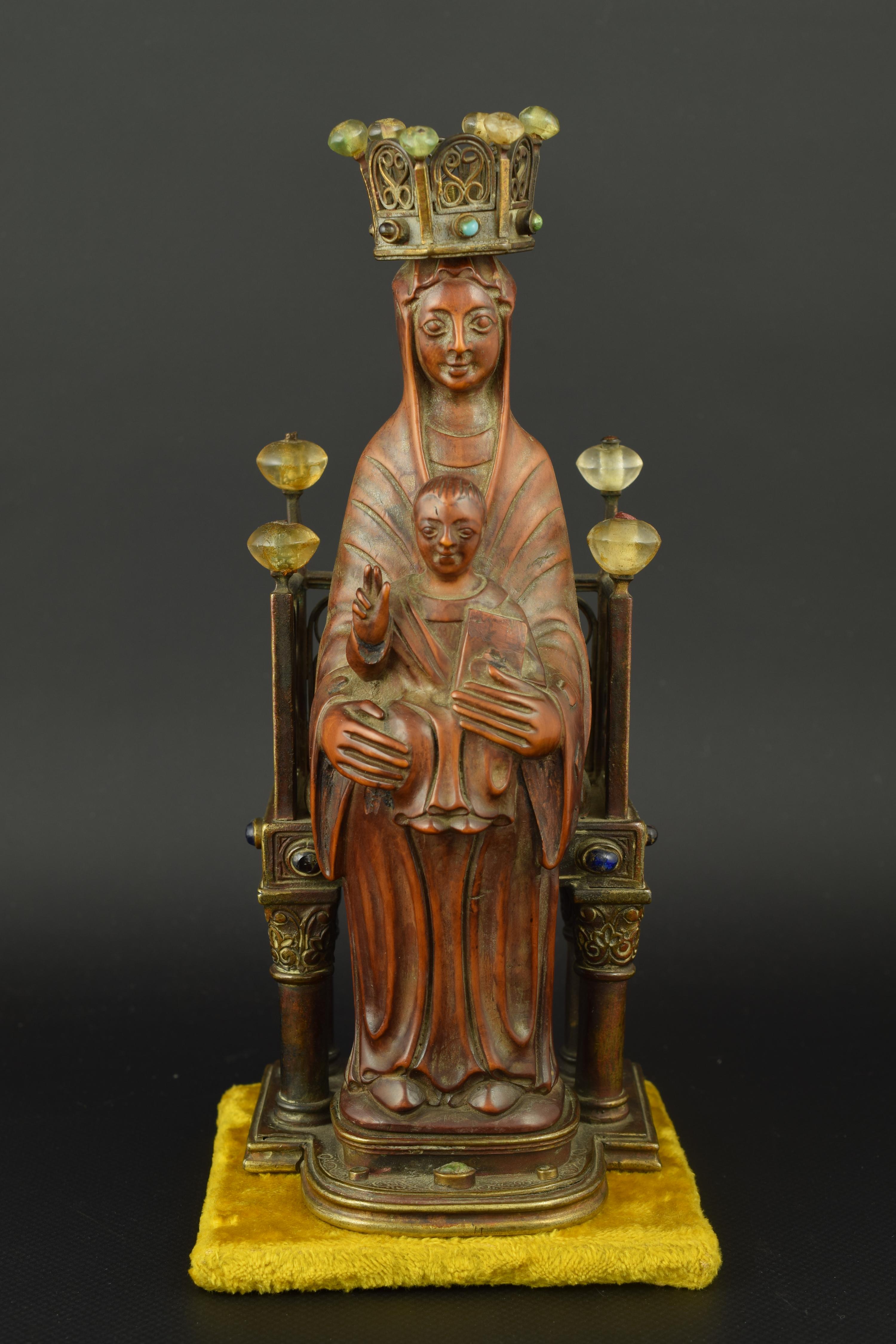 Virgin with Child enthroned. Boxwood, bronze and carved rock crystal. XIX century. 
 On an upholstered base, another second base has been placed in bronze, the metal in which the throne is made. It stands on four low columns with smooth shafts with