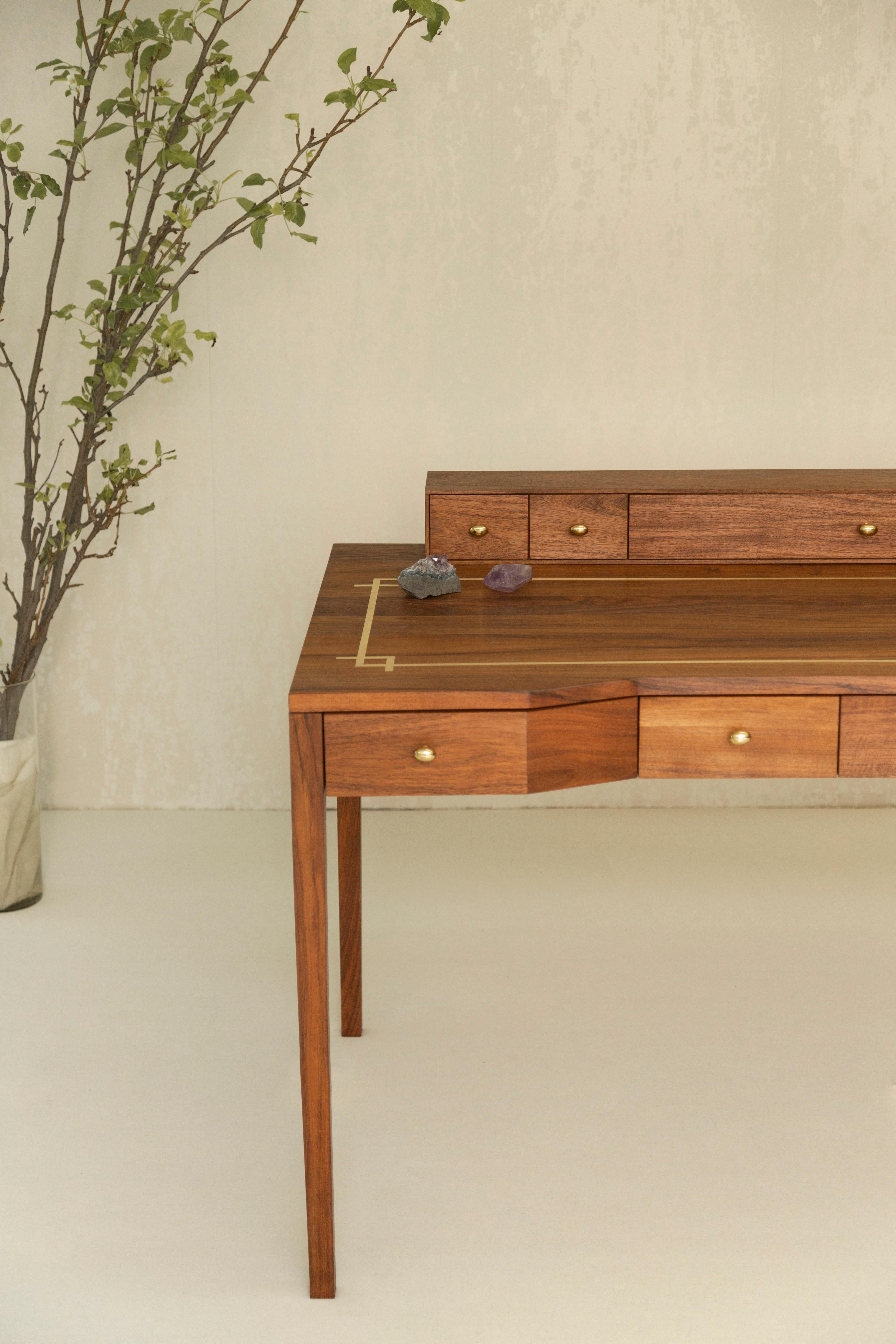 The Virginia desk was inspired by one of our favorite authors. It has features that pay homage to the love of collecting pens and small articles. Their ir a beautiful brass inlay that marks the space of creativity and creation. The desk is wide