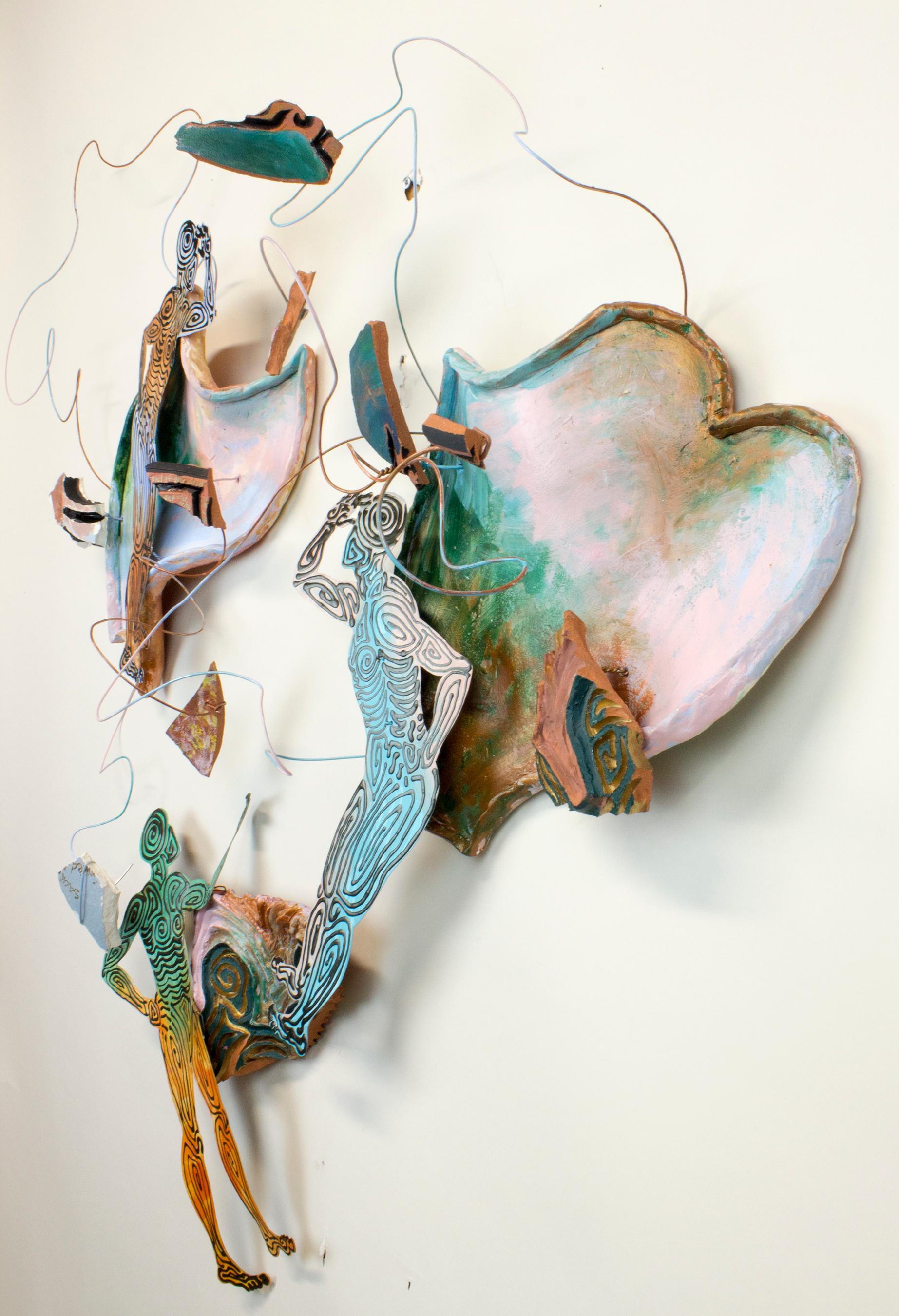 Virginia Mahoney’s “Neither Here nor There” is a 34 x 34 x 8 inch 3-piece ceramic and metal wall sculpture in green, pink, blue, black, green, orange, and brown. Three cutout figures in multicolor and black painted metal interact with shards, wire