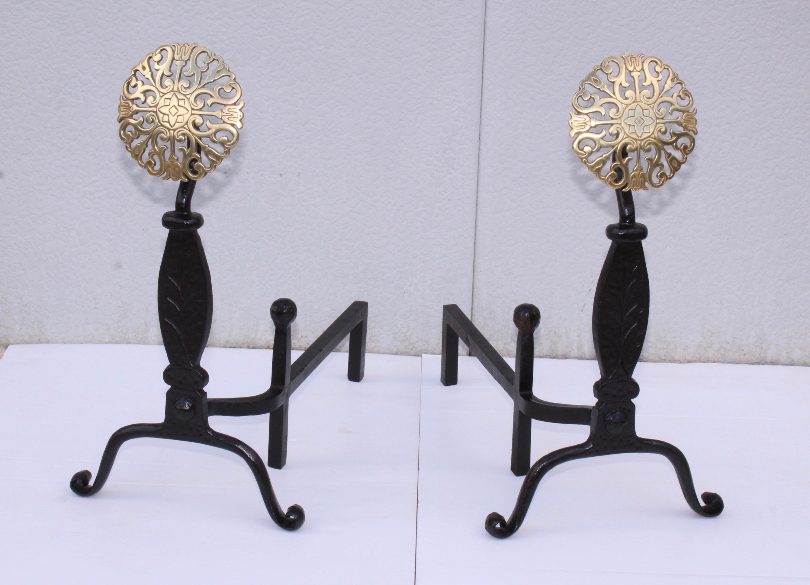 Stunning set of 1940s well made and heavy iron with solid brass medallions andirons by Virginia Metalcrafters.