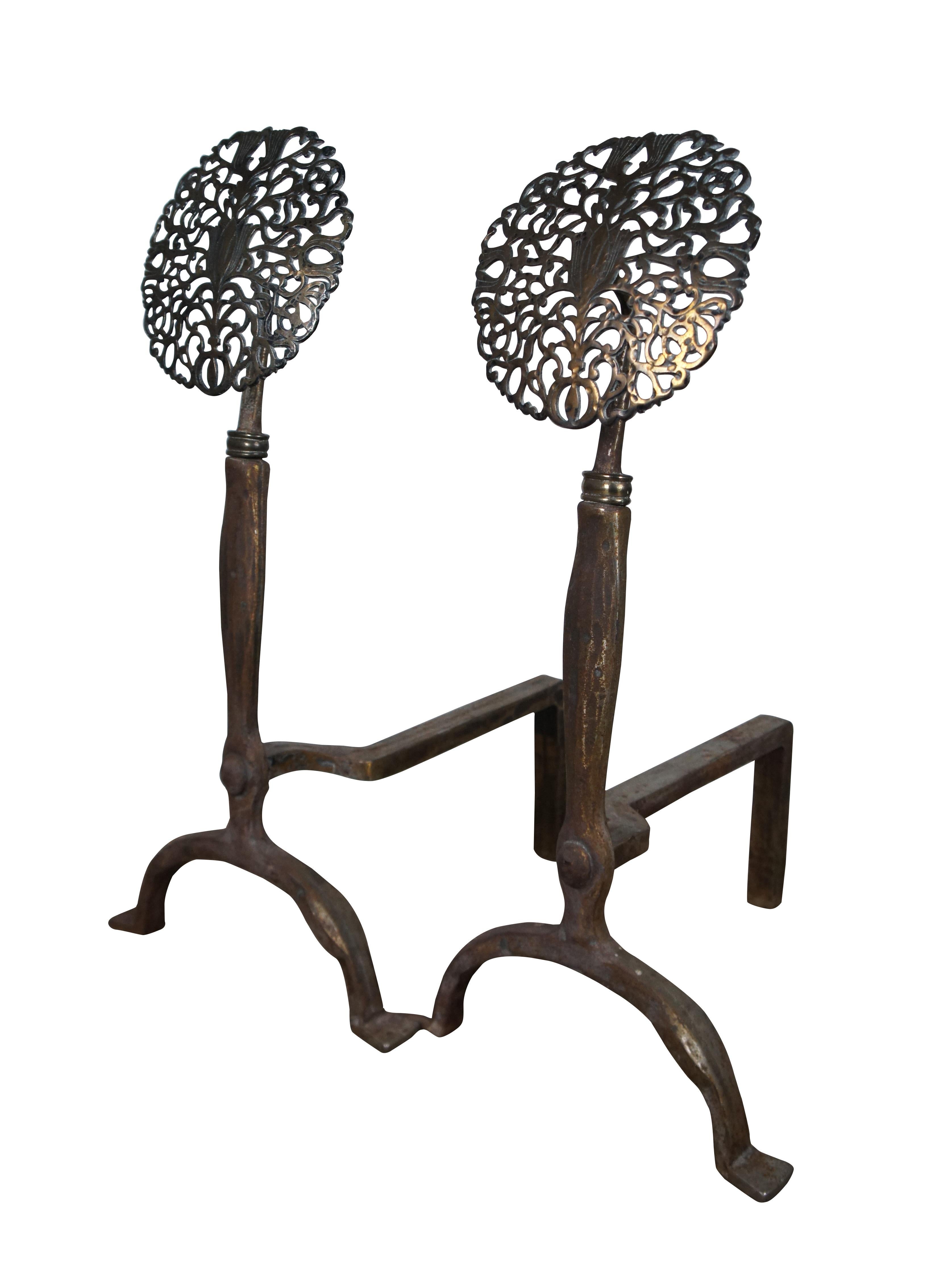 Antique Art Deco J Loth Stoves Virginia Metalcrafters arts and crafts style andirons / firedogs featuring bow legged iron bases topped with a pierced floral filigree medallion. Marked with number 100 on base. 

Dimensions:
13.25