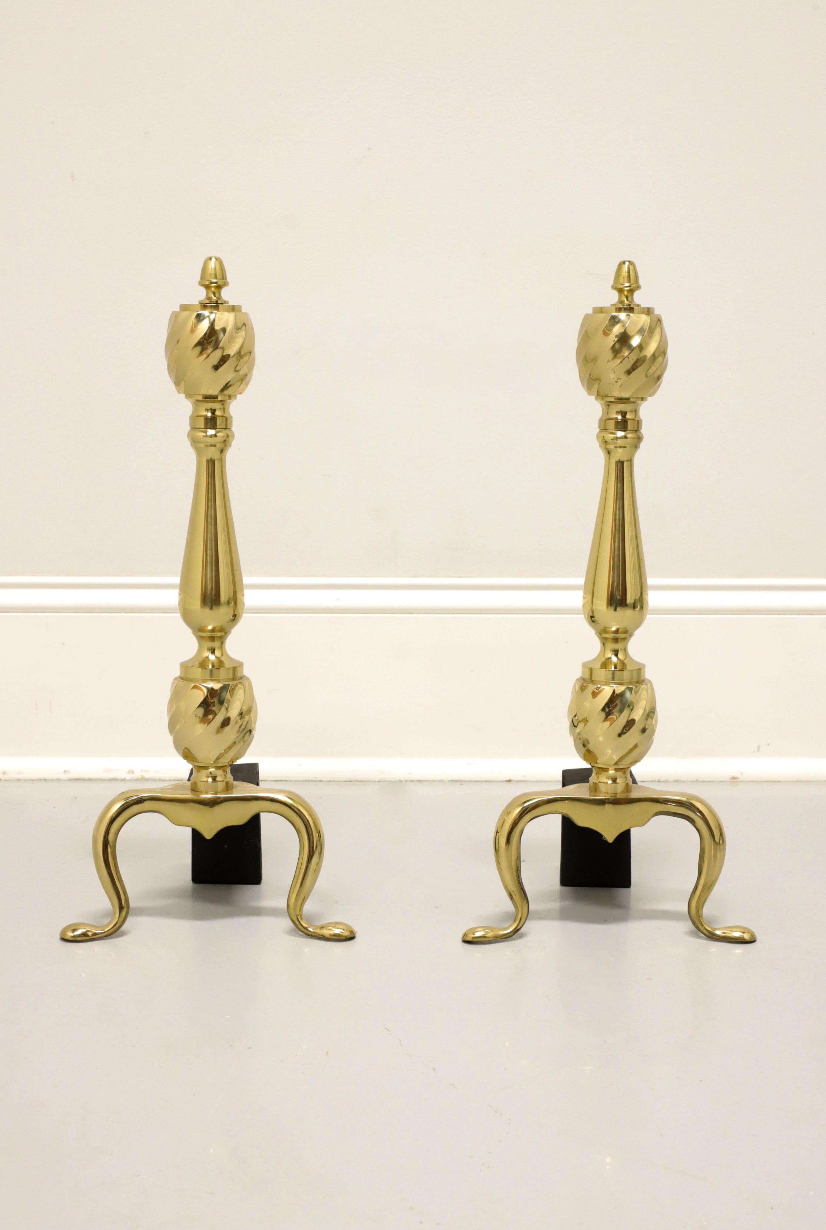A pair of Traditional style fireplace andirons by Virginia Metalcrafters. Solid polished brass andirons and black iron metal billets. Andirons have a pine cone shape to the finial, a decorative swirl pattern to finial & plinth, cabriole legs and pad