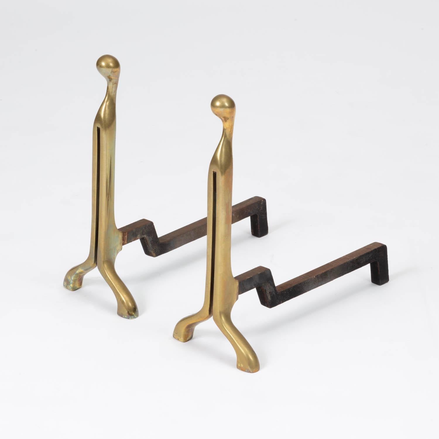 A pair of modernist fireplace andirons by Virginia Metalcrafters. The minimal curved Front Design is made of brass with cast iron stands.

Condition: Excellent vintage condition with age appropriate patina.

Dimensions: 8.5” width x 17” depth x