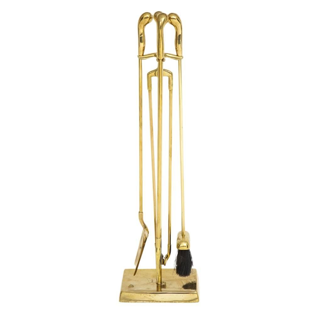 Virginia Metalcrafters brass fire tools. Compact set of  fireplace tools designed by Nancy Ruben for Virginia Metalcrafters. Made of solid brass with a clear lacquer finish and pistol grip shaped handles. Five piece set includes: shovel, brush,