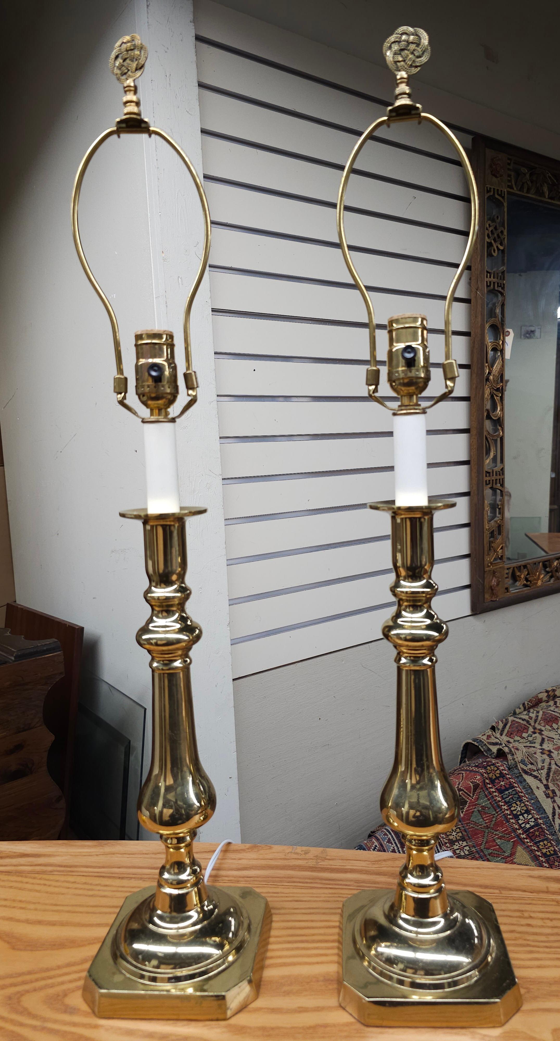 A pair of Virginia MetalCrafters Solid Polished Brass Candle Stick Table Lamps with harp and finials. Measure 5.5