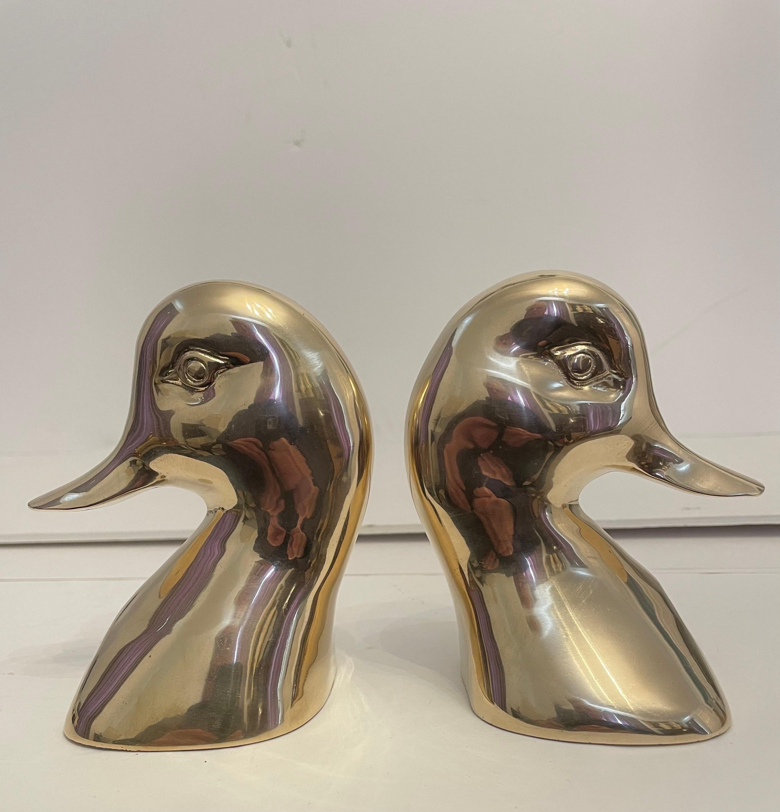 Vintage brass Duck bookends in the style of Virginia Metalcrafters, Good condition. Has nice weight to hold a stack of books. Felt on bottom. Great for your desk or bookshelf. Any light or dark areas are reflection only. Good condition, hand