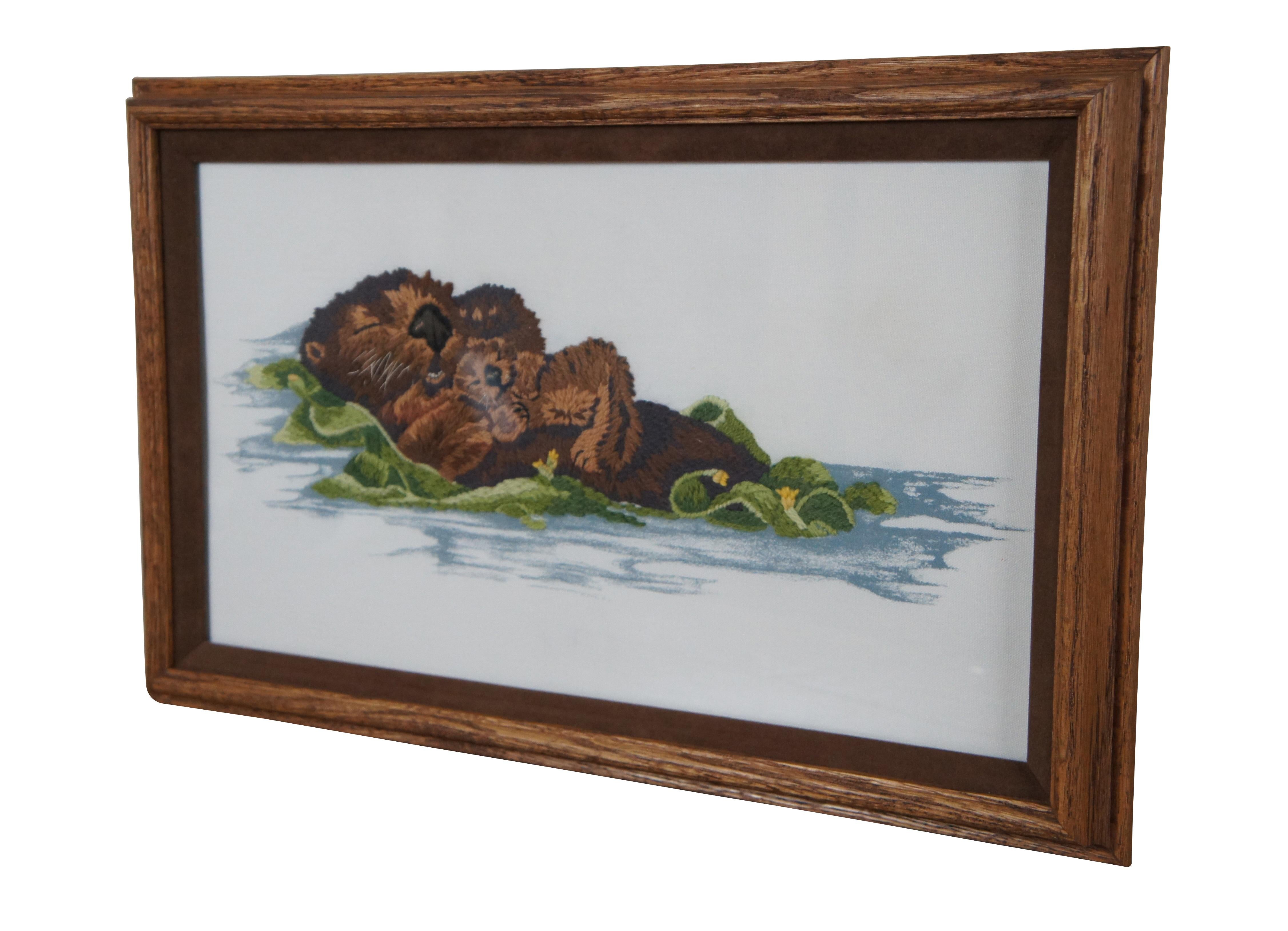 Vintage framed piece of crewel needlepoint embroidery / cross stitch art depicting a sea otter and pup floating in a bed of seaweed. Design by Virginia Miller; kit originally produced by Janlynn circa 1988.


DIMENSIONS

19.75