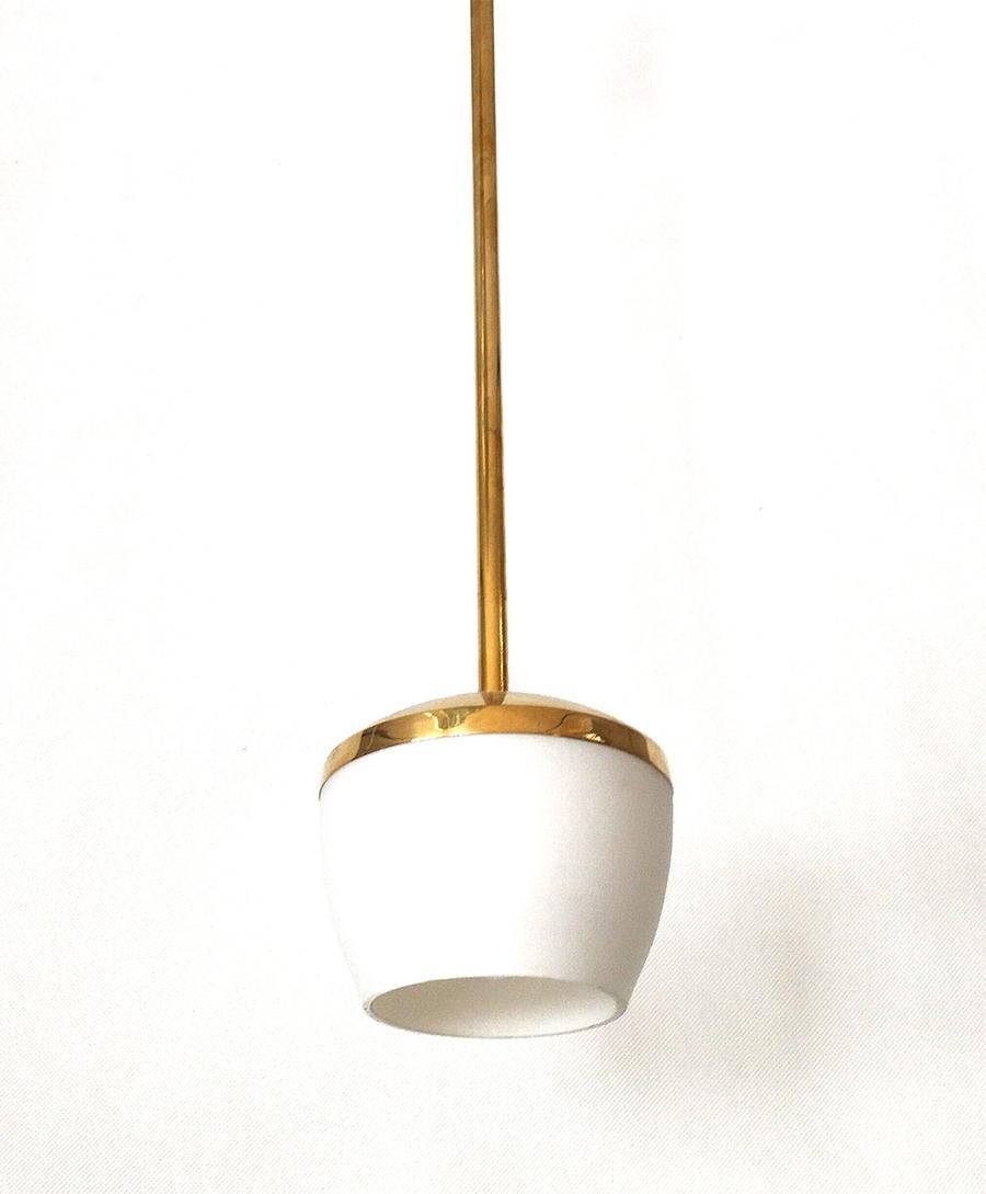 Customizable pendant light made of solid brass and glass shade in matte white.
Finished and assembled by hand by Candas artisans.

Top can be made in solid brass rod assembled to canopy or with brass chain (contact us for more