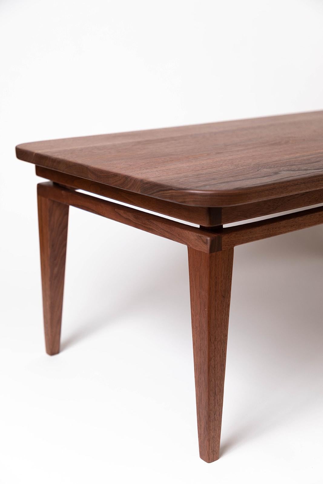 Visaeti Coffee Table. Visaeti, in old church Slovanic, means to hoover, to soar, to linger in the air. This highly constructed coffee table gives an airy floating feel while being firmly planted on the ground. Shown in walnut at 39