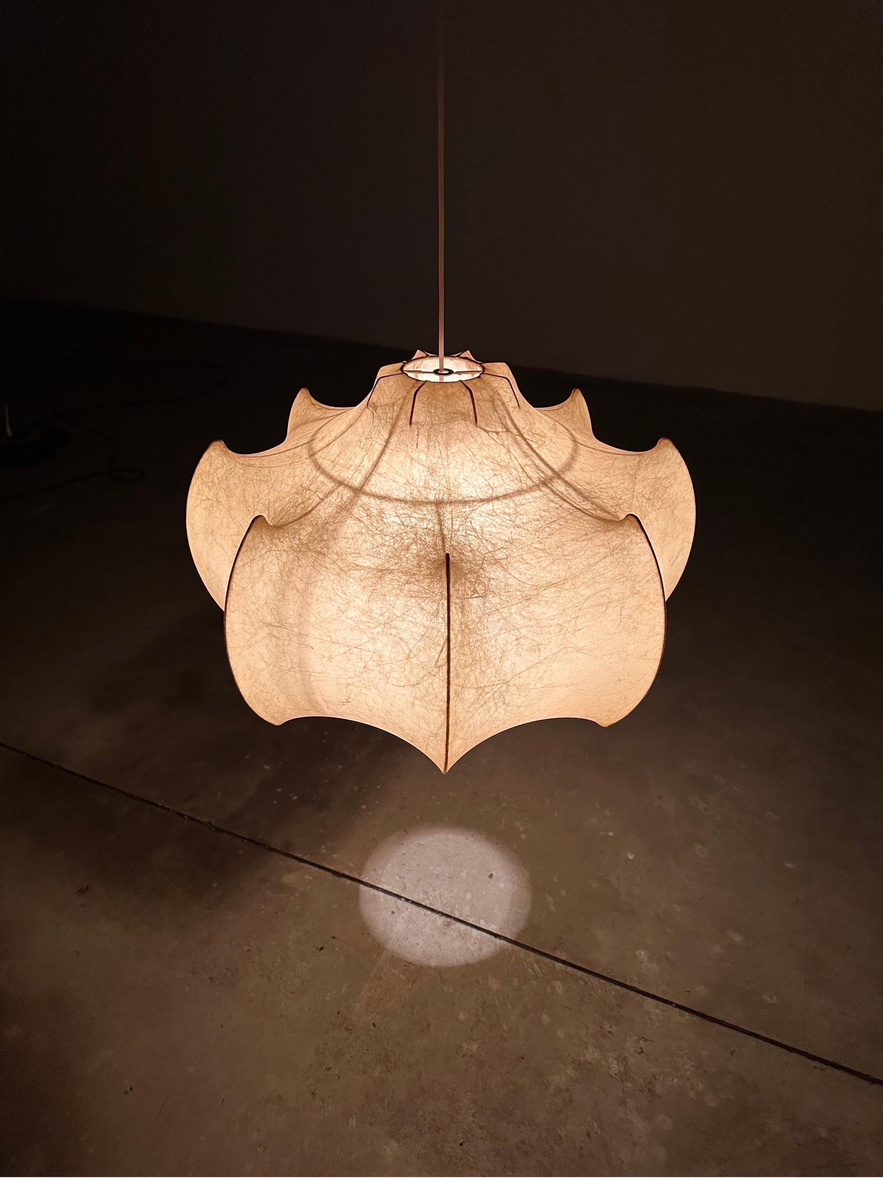 This particular piece boasts a unique charm, characterized by a captivating patina that tells the story of its rich history.

Crafted during the early years of production, this ceiling lamp stands as a testament to the Castiglioni brothers'