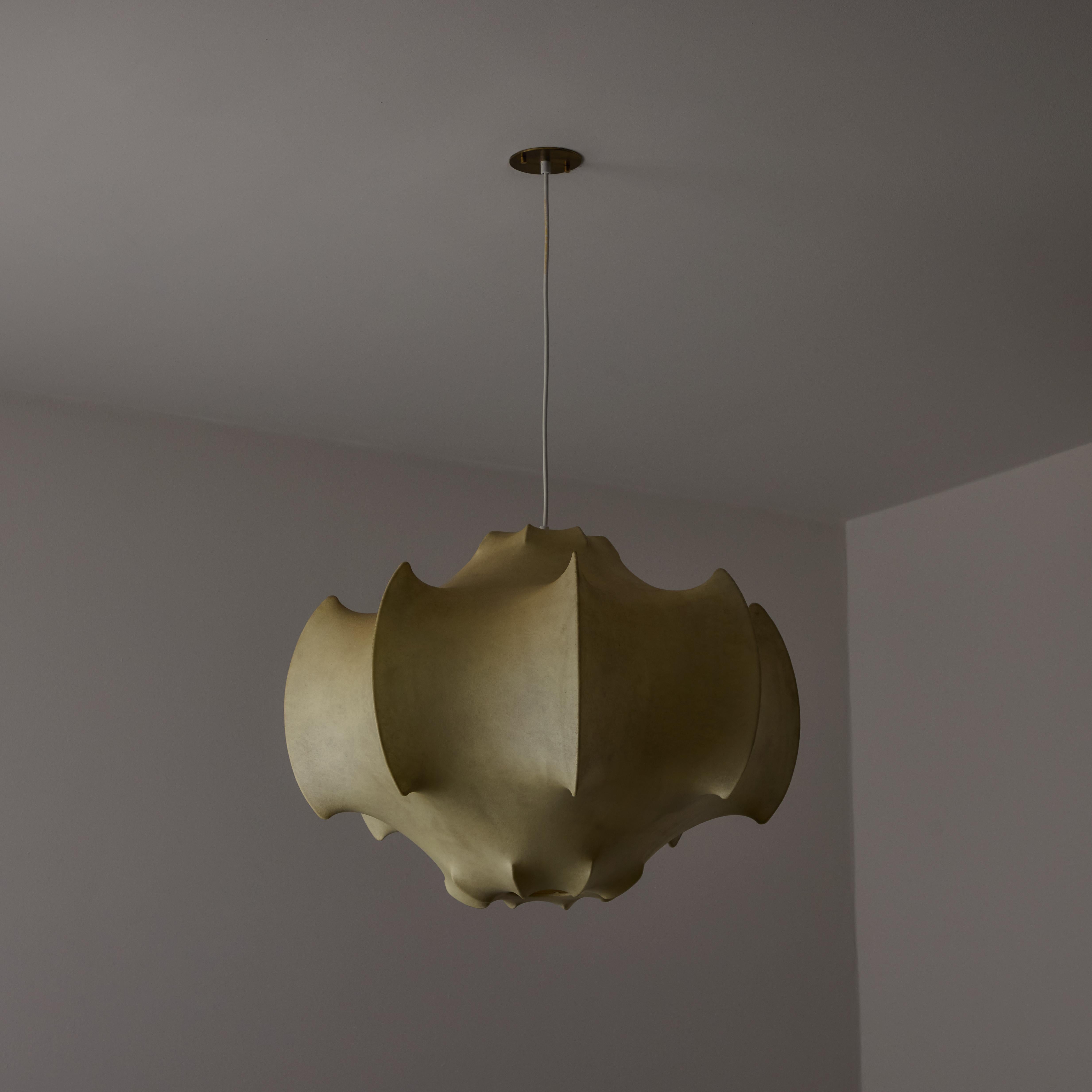 First edition Viscontea suspension light by Achille & Pier Castiglioni for Flos. Designed and manufactured in Italy, circa 1960s. Iconic fiberous pendant by Flos. Resin, steel enameled frame, and a custom brass US backplate. Wired for U.S. Holds a