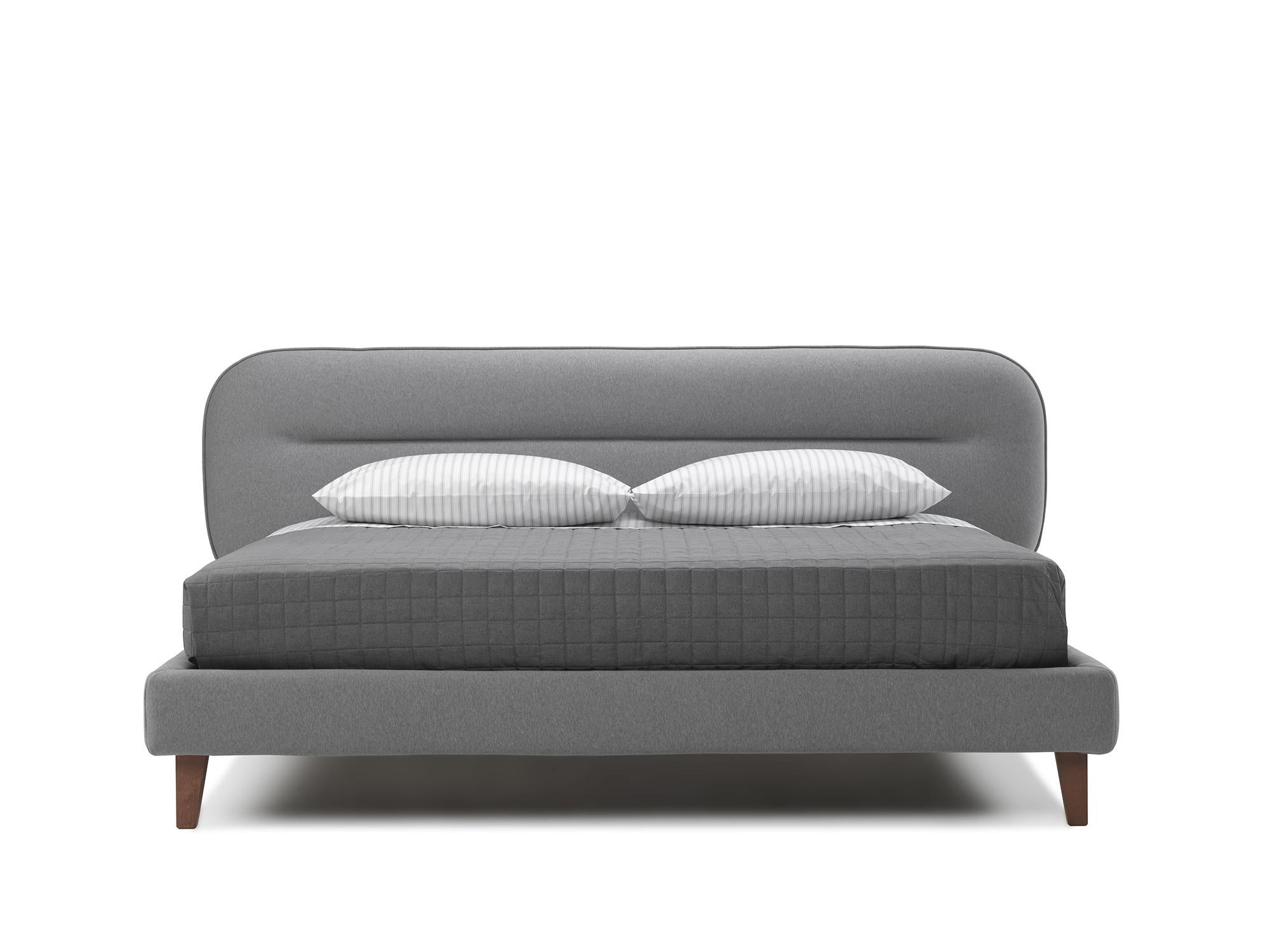 Bed with a young and trendy line for style-conscious customers. It evokes the forms of the 1960s and 1970s when the Italian design reached its pinnacle. The aesthetical detail of the upholstered headboard contributes to a beautiful and unique item: