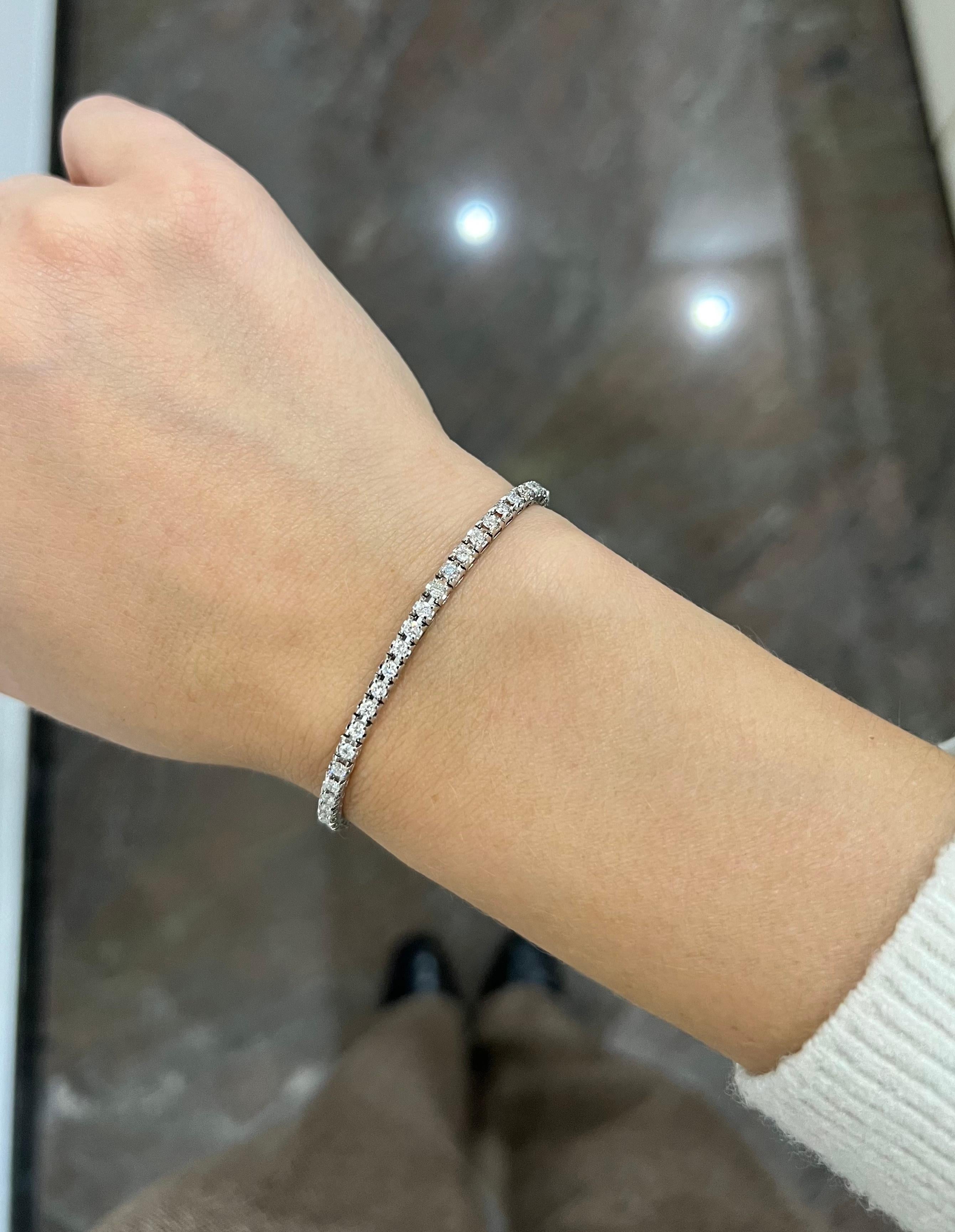 Elevate your style with this exquisite 18K White Gold Four Prong Tennis Bracelet. Crafted with meticulous attention to detail, it features a continuous line of dazzling round-cut natural diamonds, totaling 5.00 carats.

 Each diamond is expertly
