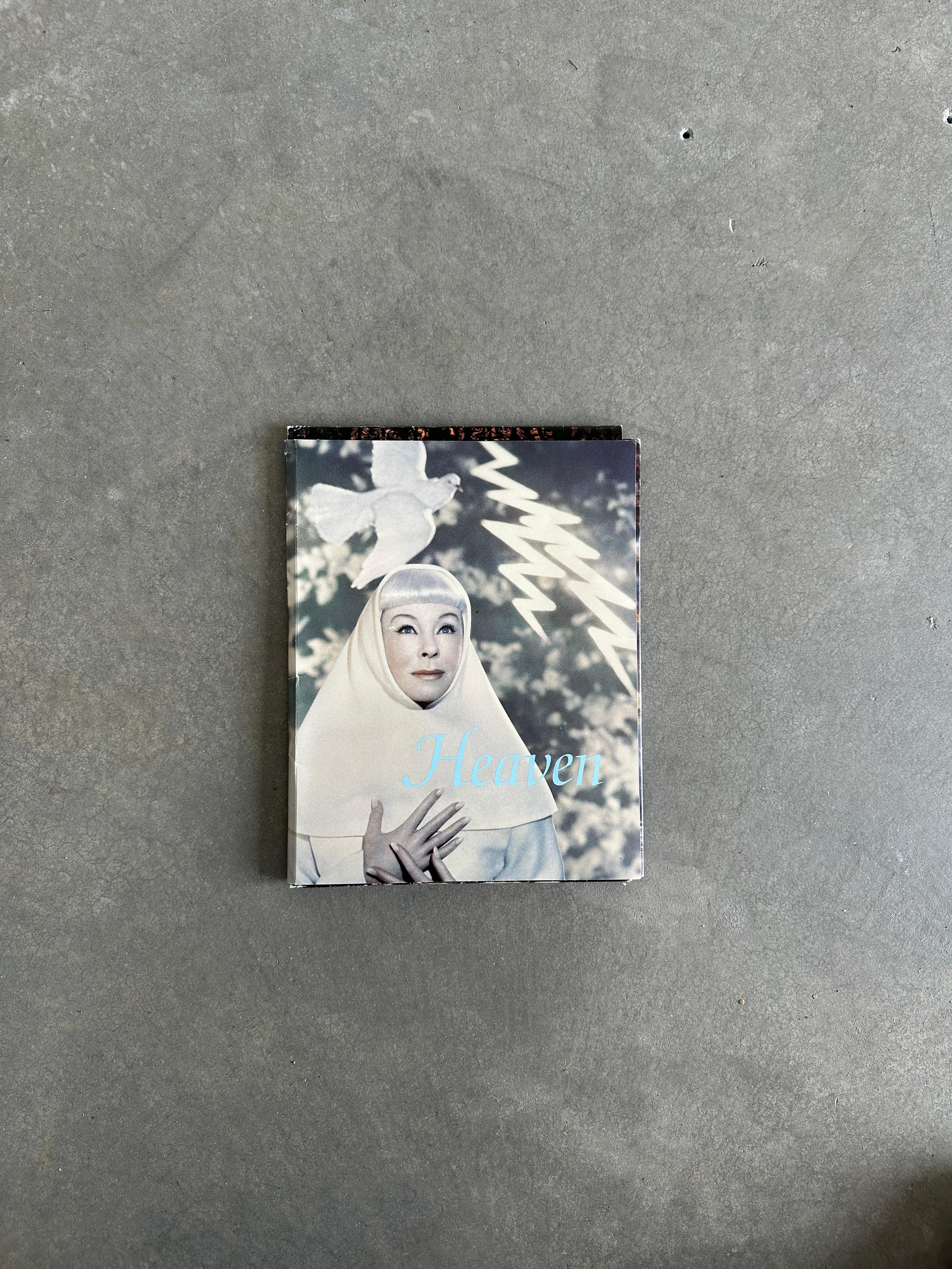 From the Visionaire website:

The work of the Saints of Pierre et Gilles makes up the backbone – and the cover – of 4 HEAVEN, a precious issue. Todd Oldham’s embroidered-silk clouds, for example, were made in India, and we then cut them up together