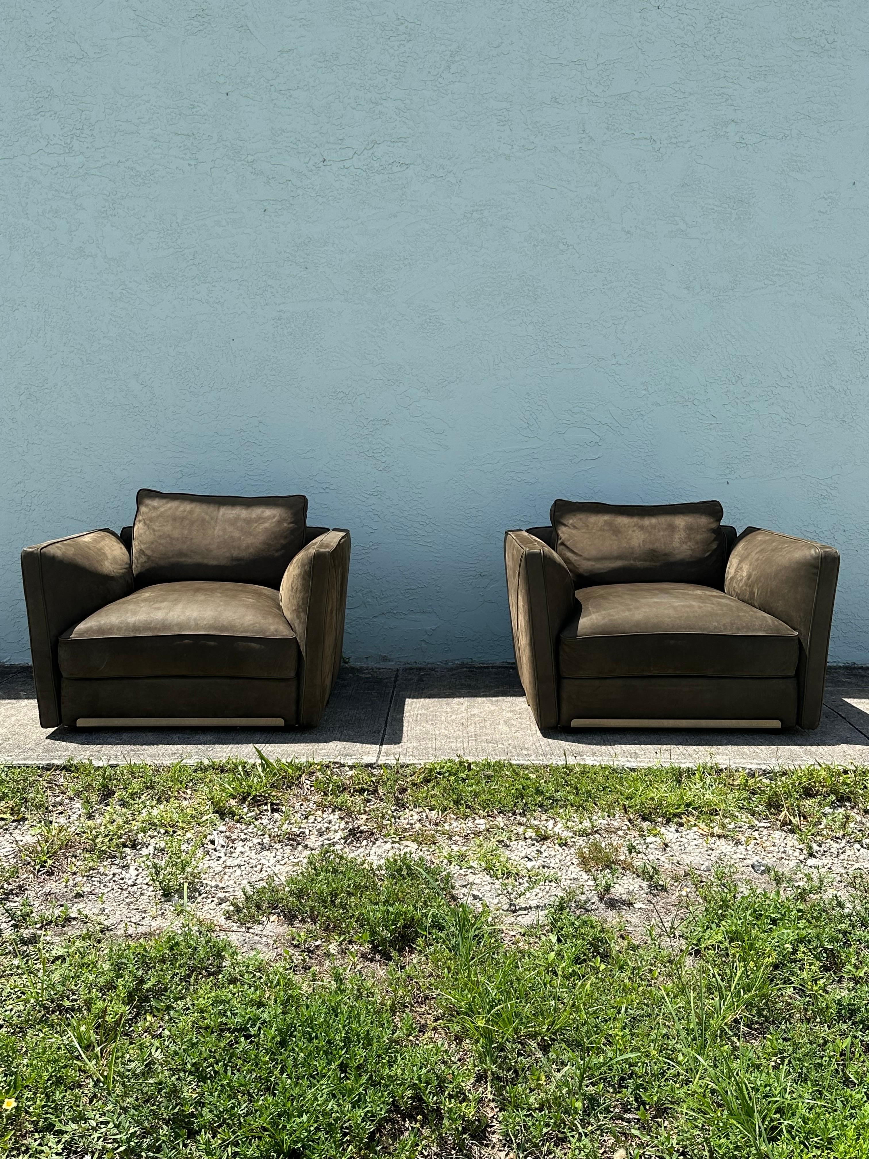 Transport yourself back to the sleek and sophisticated 1990s with this exquisite olive suede knole style chairs. The ultra rare chairs exudes an air of luxury and refinement. Outstanding design is exhibited throughout. The luxurious chair is