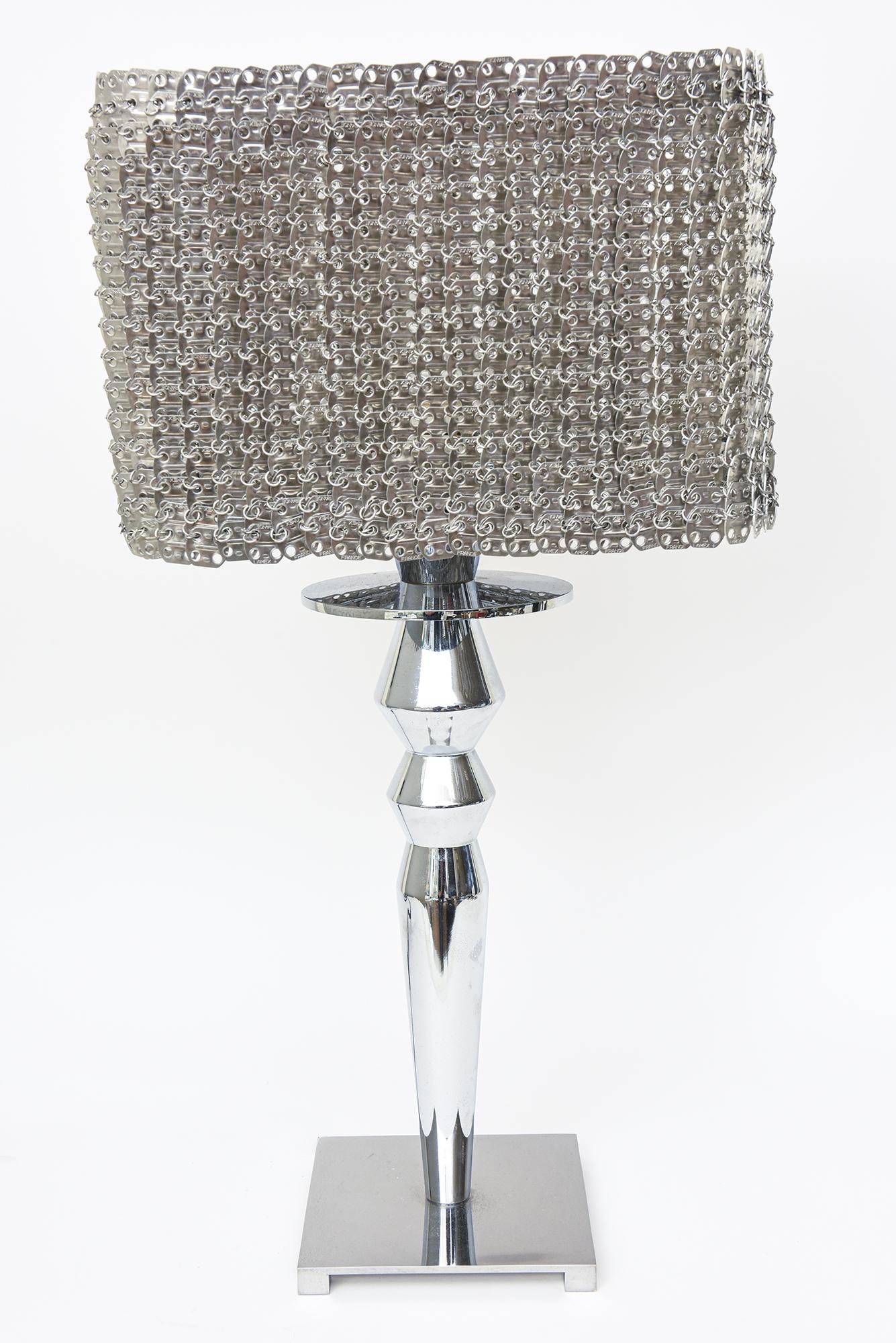 This great Italian Visionnaire Isotta table lamp is aluminum with chain link metal aluminum original chic shade. It has great ambient lighting at night through the chain link shade. It is no longer available through the company or no longer in