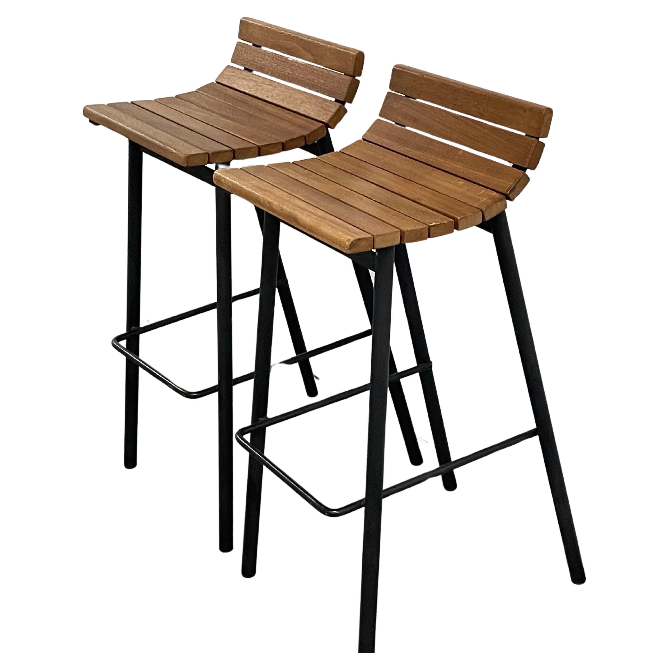 Classic mahogany and iron bar stools made by Vista of California, c.1950s. 

Great design. These very comfortable bar height stools feature mahogany wood slats for the seats and powder coated tubular steel frames with a thinner strip of steel tubing