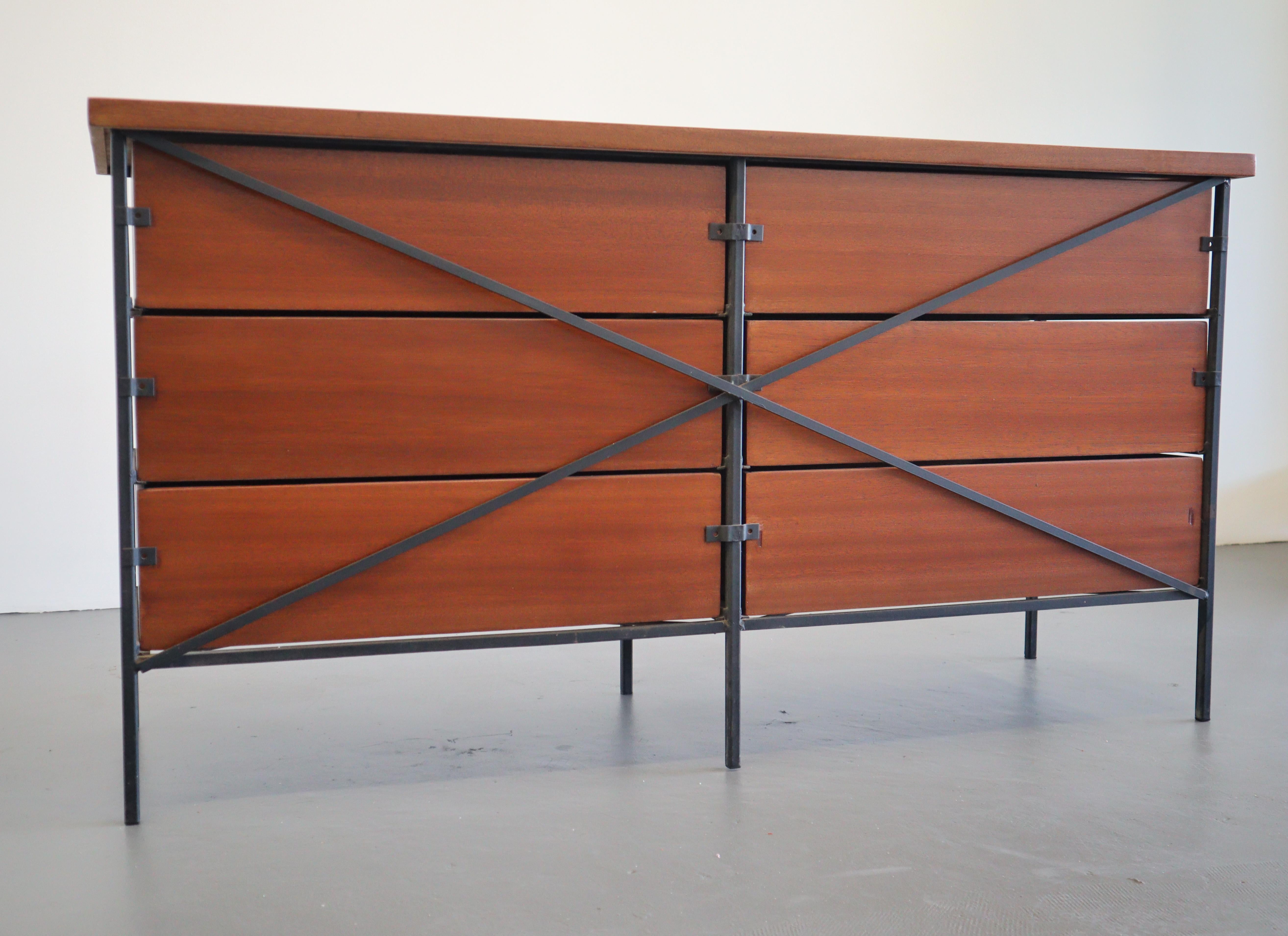 Classic Mid-Century Modern design that is California cool and timeless. A distinguished piece that is unique with its steel frame accented with chrome hardware. This mahogany 6 drawer dresser was designed in California circa 1950's.