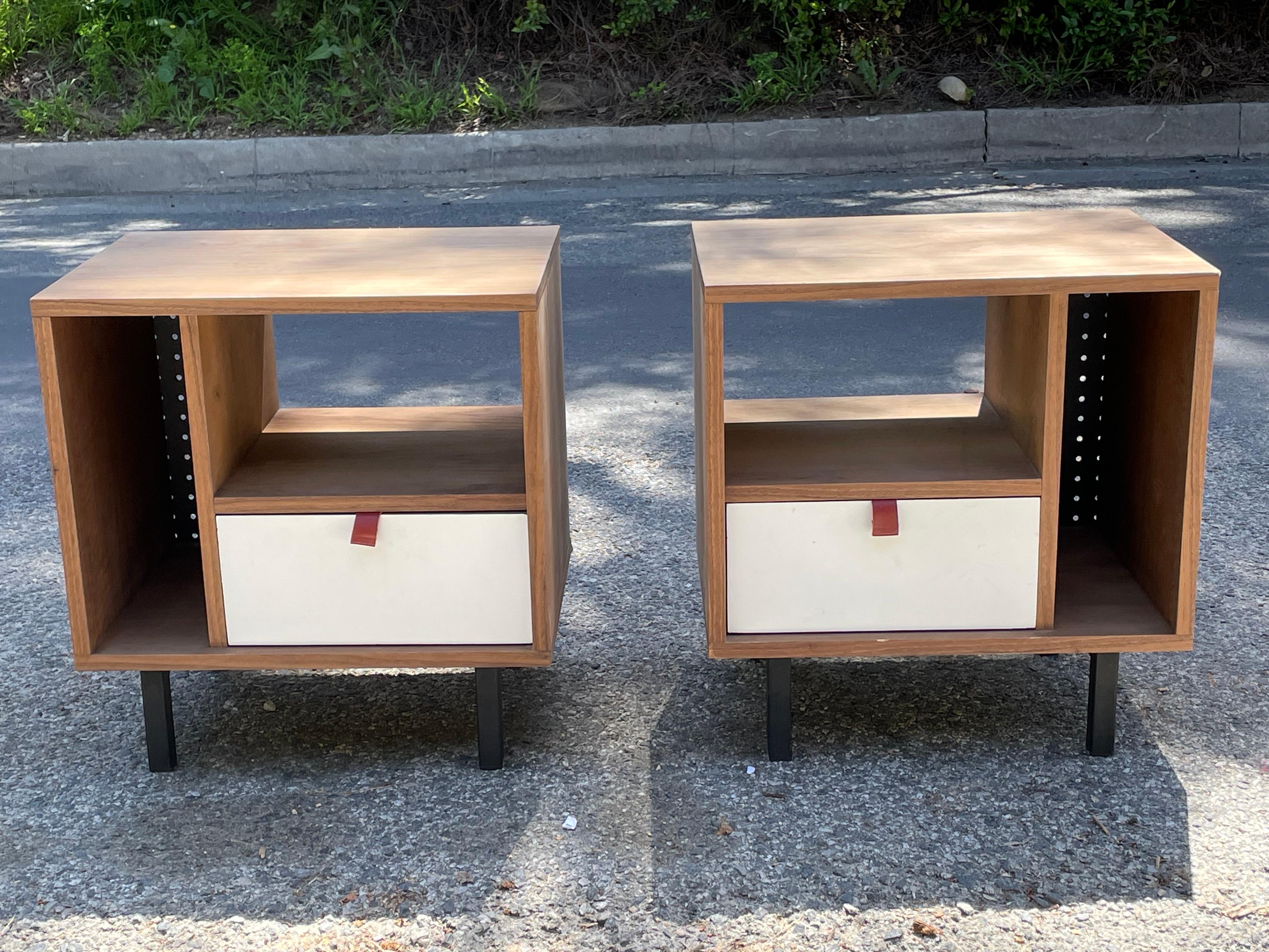 Rare design. Walnut nightstands with red leather pulls and perforated metal panelling. Metal legs. 

In the style of Donald Knorr for Vista of California style. 

Newer production. Very good condition.

We're currently pairing these