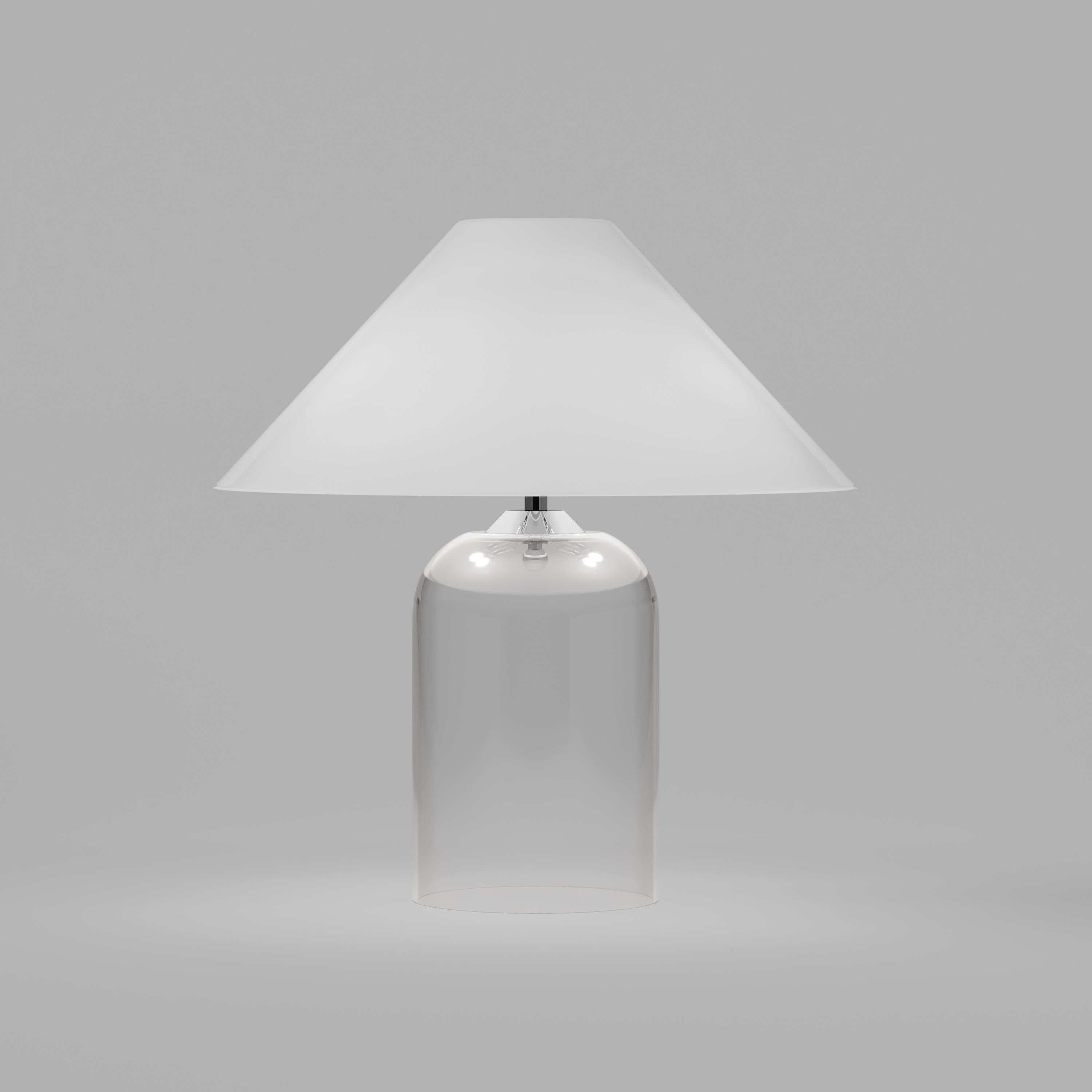 A design that combines a classical concept with a retro inspiration. The transparent base and the white diffuser give a warm accent to the light. Shade in glossy white, base in crystal. Metal parts in chrome. E12 lighting.
 