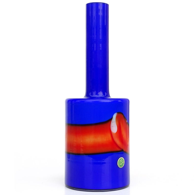 Beautiful vintage Murano hand blown bright cobalt blue and red band over white Italian art glass flower vase. Documented to designer Fulvio Bianconi for Vistosi, circa 1960s. He worked for the company between 1953-1965. The vase still retains an