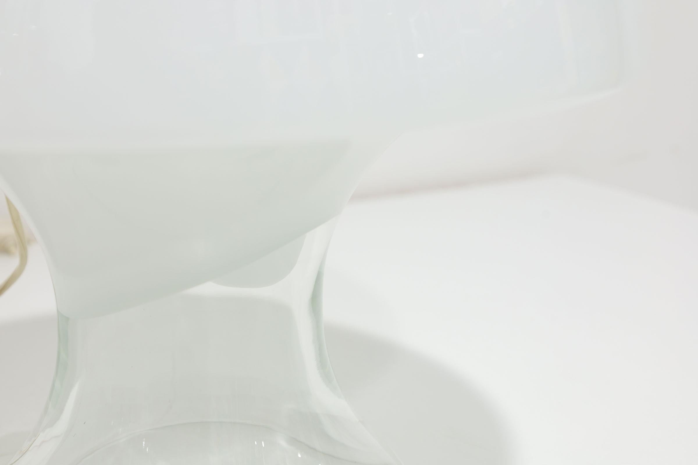 The Cumulus Lamp by Vistosi was designed in the 1960s by Enrico Capuzzo. White opal and clear crystal hand blown Murano glass lampshade. Opaque on top, terminating clear at the base.