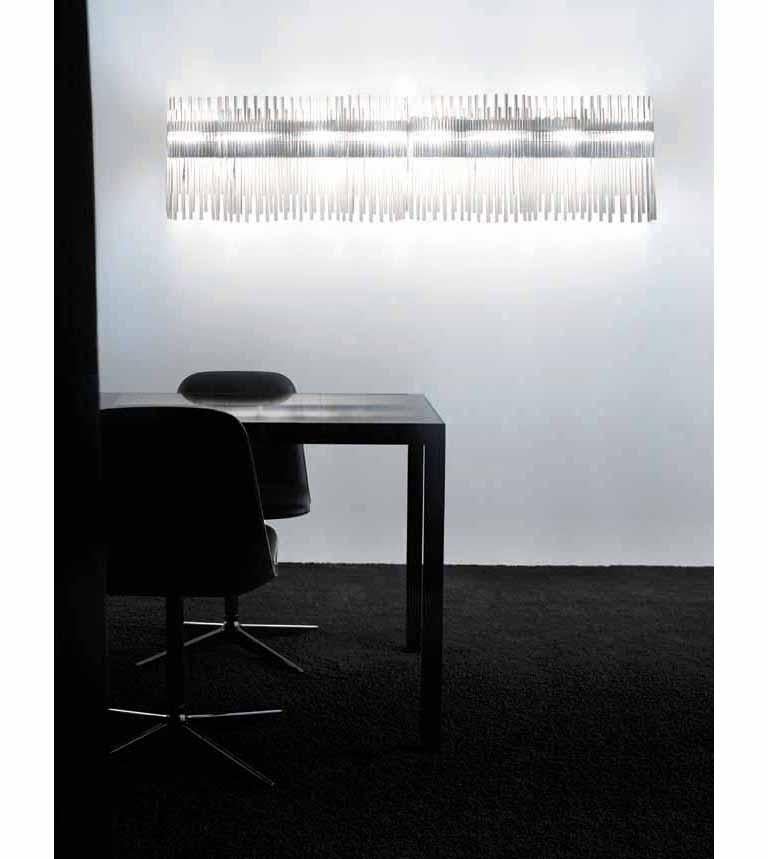 The Diadema collection is a lighting system based on a single element a rod of pure glass. This crystal sconce takes advantage of the way it reflects and transmits the light while offering a sense of movement by using rods of different sizes. The