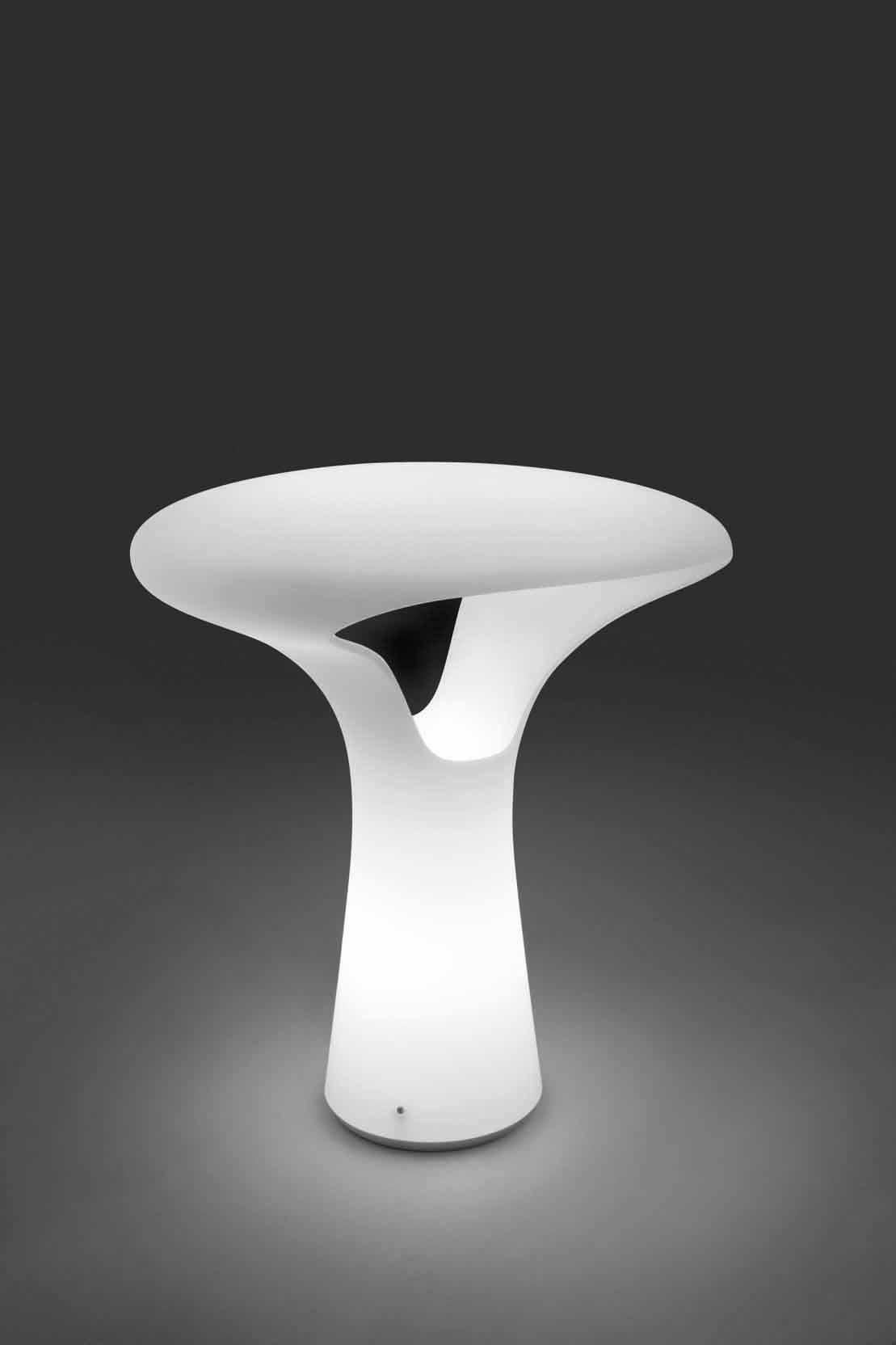 A uniquely designed table lamp made possible by the use of a water-jet cut, allowing for the designer to explore and create shapes that give a new direction to the traditional use of Murano glass. Glass color tone in satin white. Metal parts in