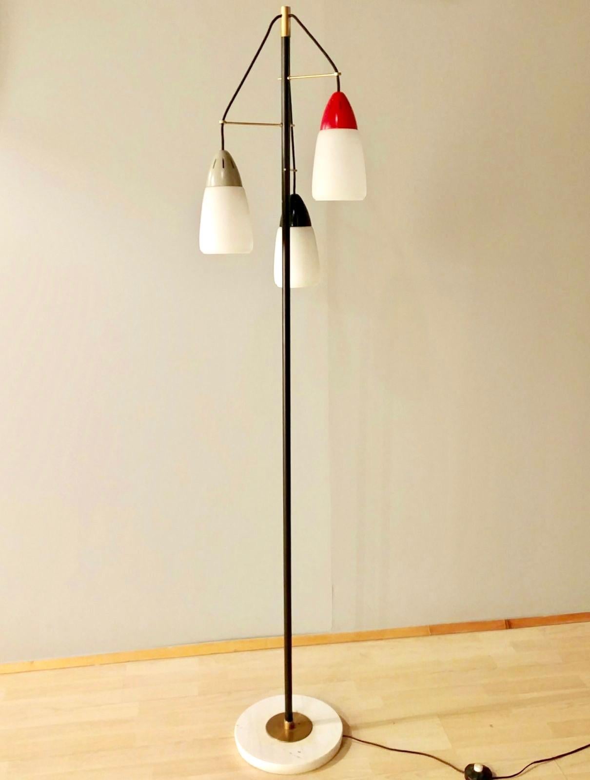 Italian floor lamp attributed to Stilnovo, 1956
Lamps features three lights, solid brass hardware that has been polished and sealed, opaline glass shades, marble base.
