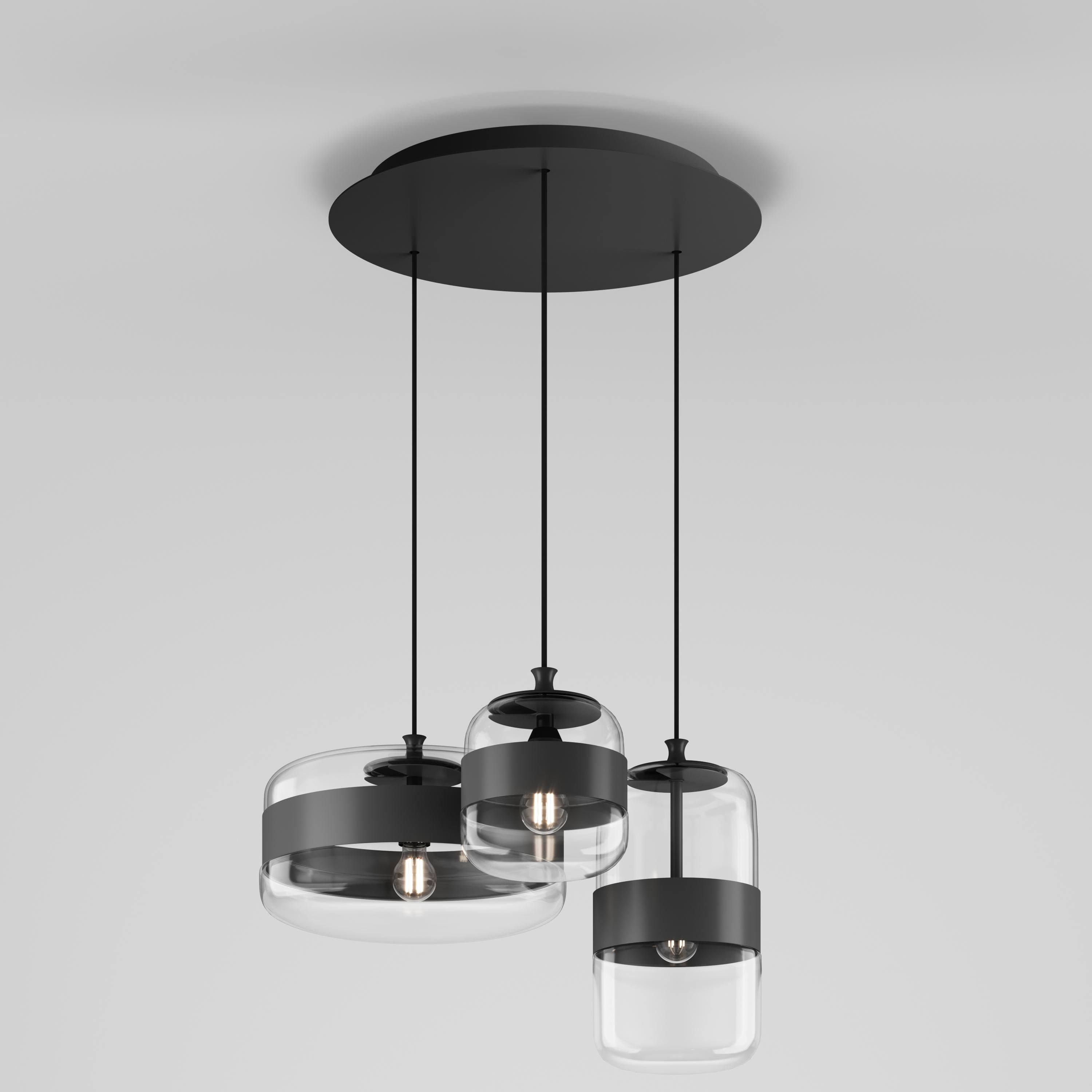 A collection of lamps made from a single piece of blown glass, whose particular workmanship, though, allows a double chromatic effect: transparent at the top, satin effect at the bottom. The following combinations of glass with metal ring are now