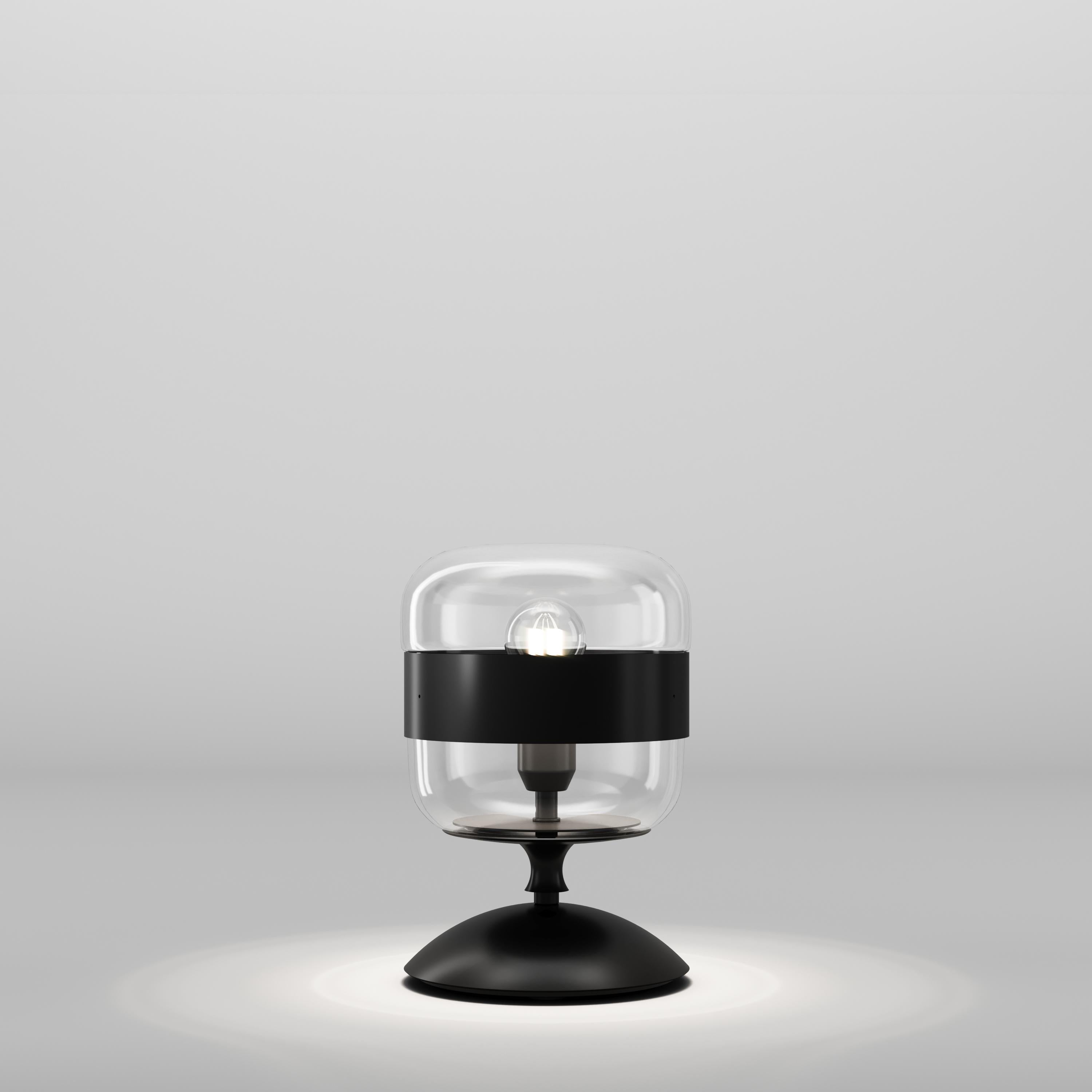 A collection of lamps made from a single piece of blown glass, whose particular workmanship, though, allows a double chromatic effect: transparent at the top, satin effect at the bottom. The following combinations of glass with metal ring are now