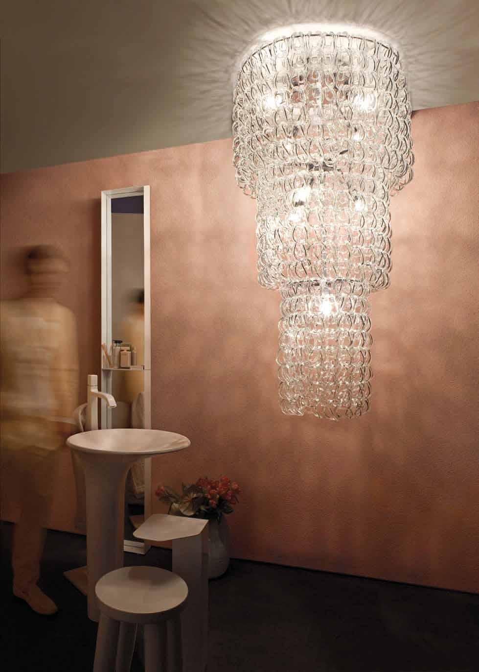 The Giogali collection is a decorative lighting system based on a single element: the handmade glass link. Featured Cascade chandelier in crystal. Metal parts in chrome. E26 lighting.
