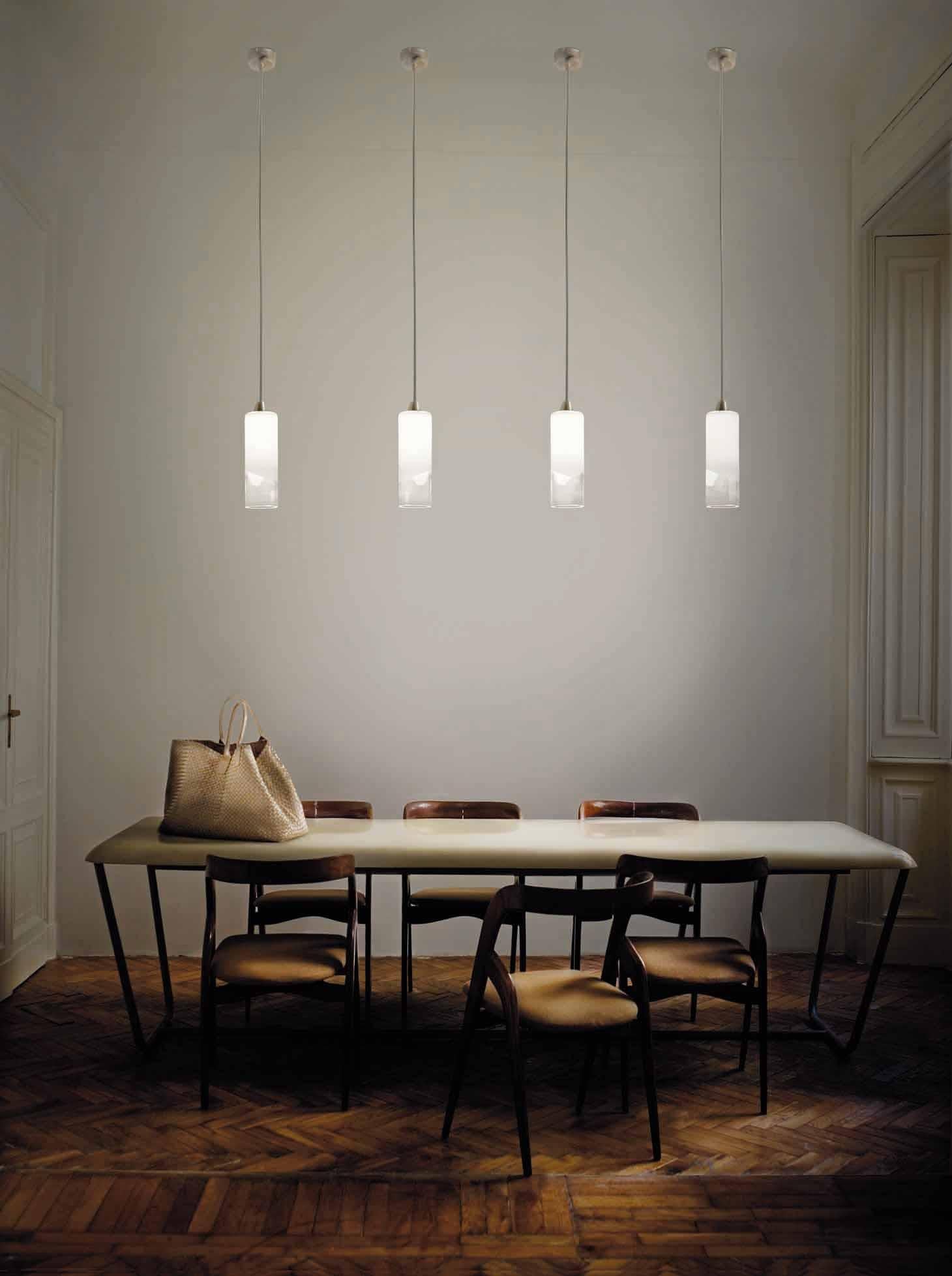 Pendant light with a minimal, unobtrusive design that makes the most of the light source, thanks to the translucent white band inserted in the glass. LED dimmable lighting. Dimensions are in reference to the light fixture and not inclusive of the