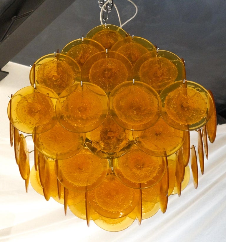 Check out this colorful chandelier, made up of 64 pure orange glass elements that make you crazy. It would be able to give joy even to a minimal white room.
Overall, it is a very simple but impressive chandelier.
It is in fact characterized by the
