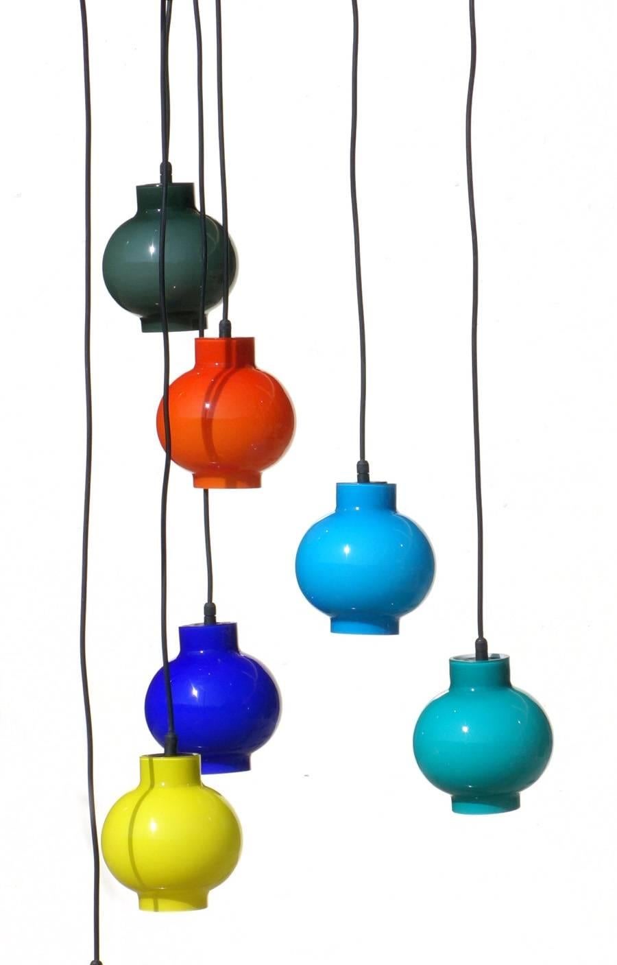 Pendant lamps
by Vistosi, 1950s

Colored glass
Black metal frame
Brass details

Measure: height 115 cm
diameter shade 13 cm.