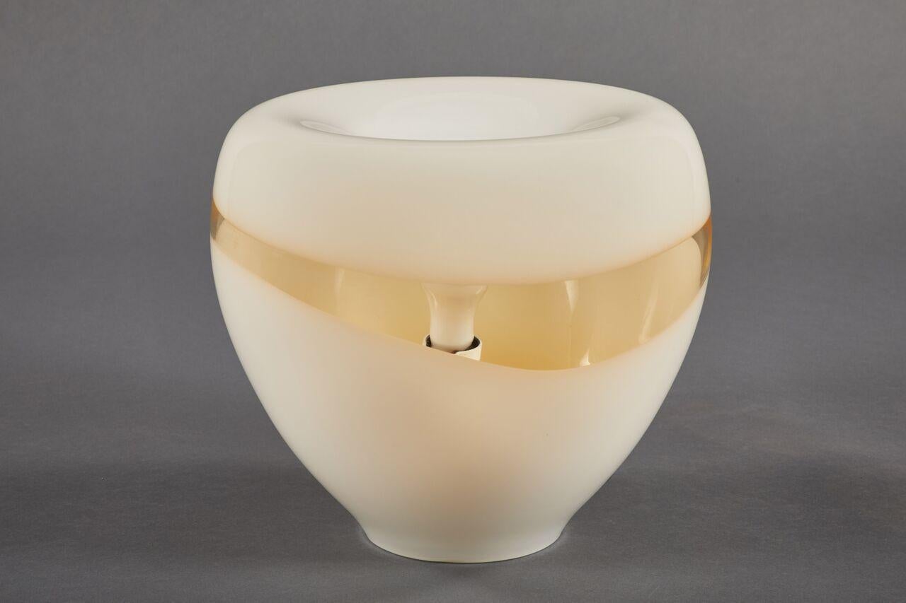 A Murano Vistosi glass table lamp in a graceful bowl shape, featuring white opaque and amber blown glass.