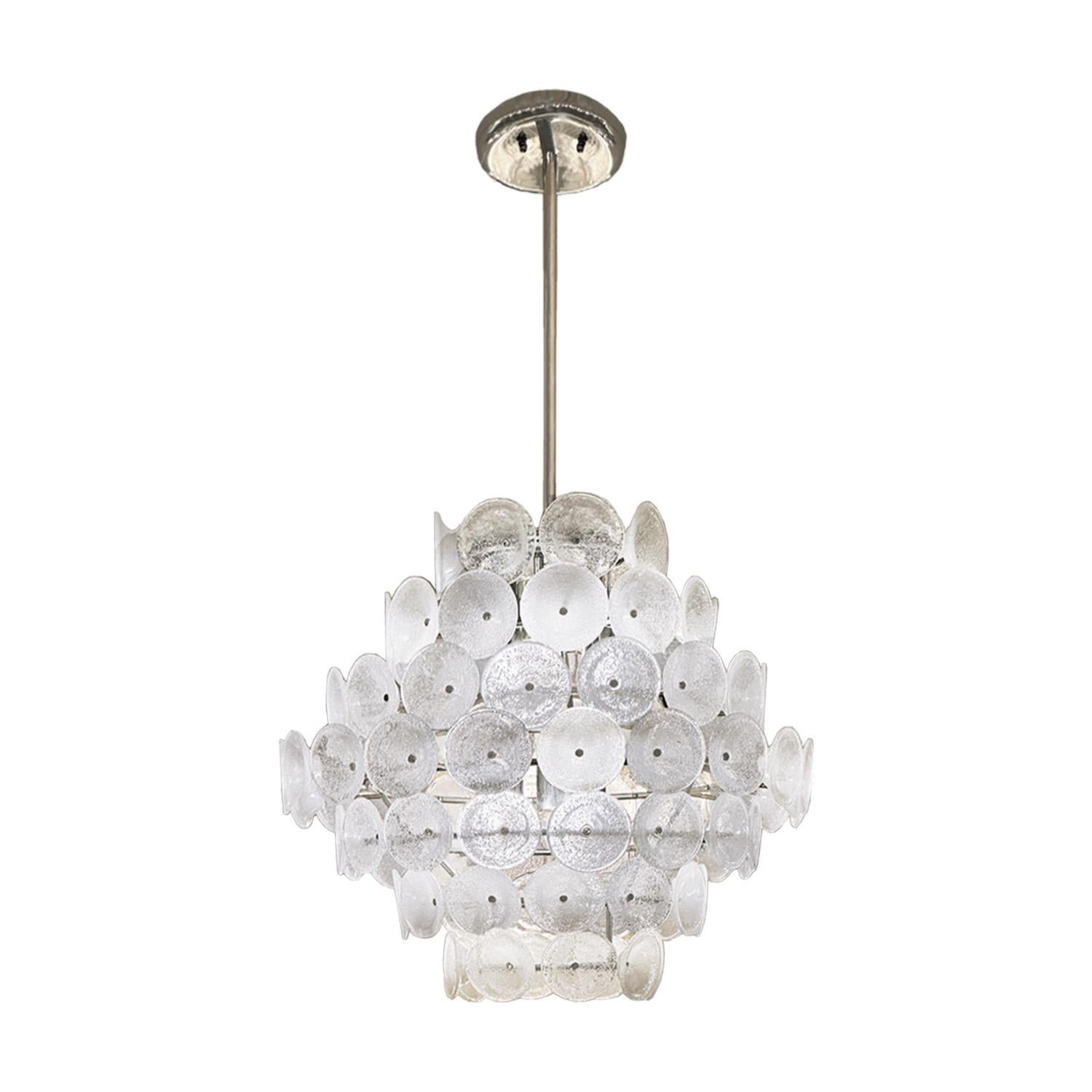 A playful variation on the glass disc, this chandelier by Vistosi Murano features concentric rings of small bell-shaped cups. The fixture is comprised of seven tiers surrounding six lights. The hand- crafted pulegoso glass is visually stunning when
