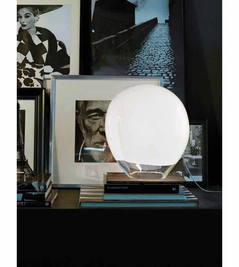 Table lamp with a transparent base that makes the most of the light source while the upper white band creates a soft ambient glow. E26 lighting.