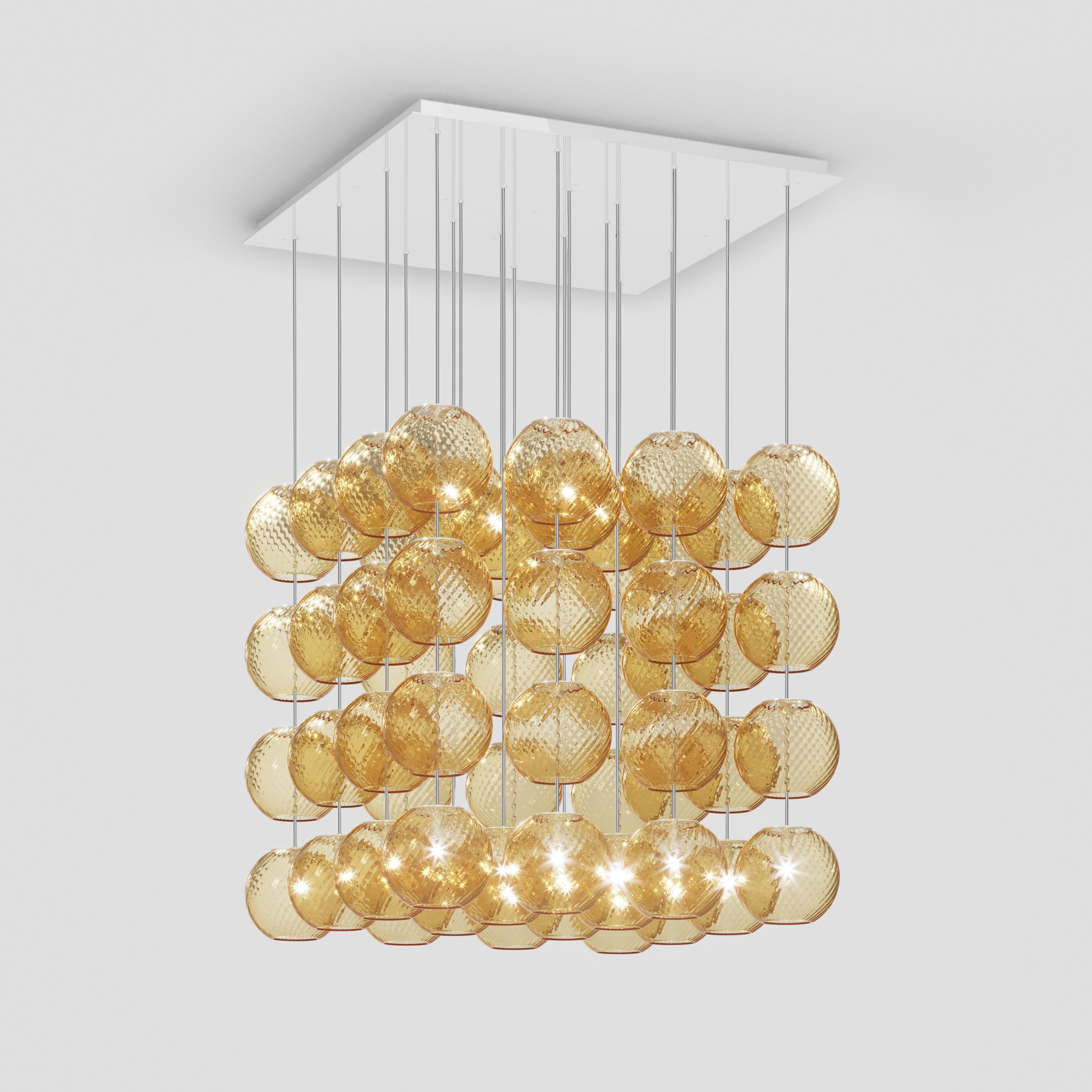 Spherical blown glass elements available in three sizes and four rigadin colours, with and without lighting source. The special design allows the vertical installation of several glass elements and infinite customized