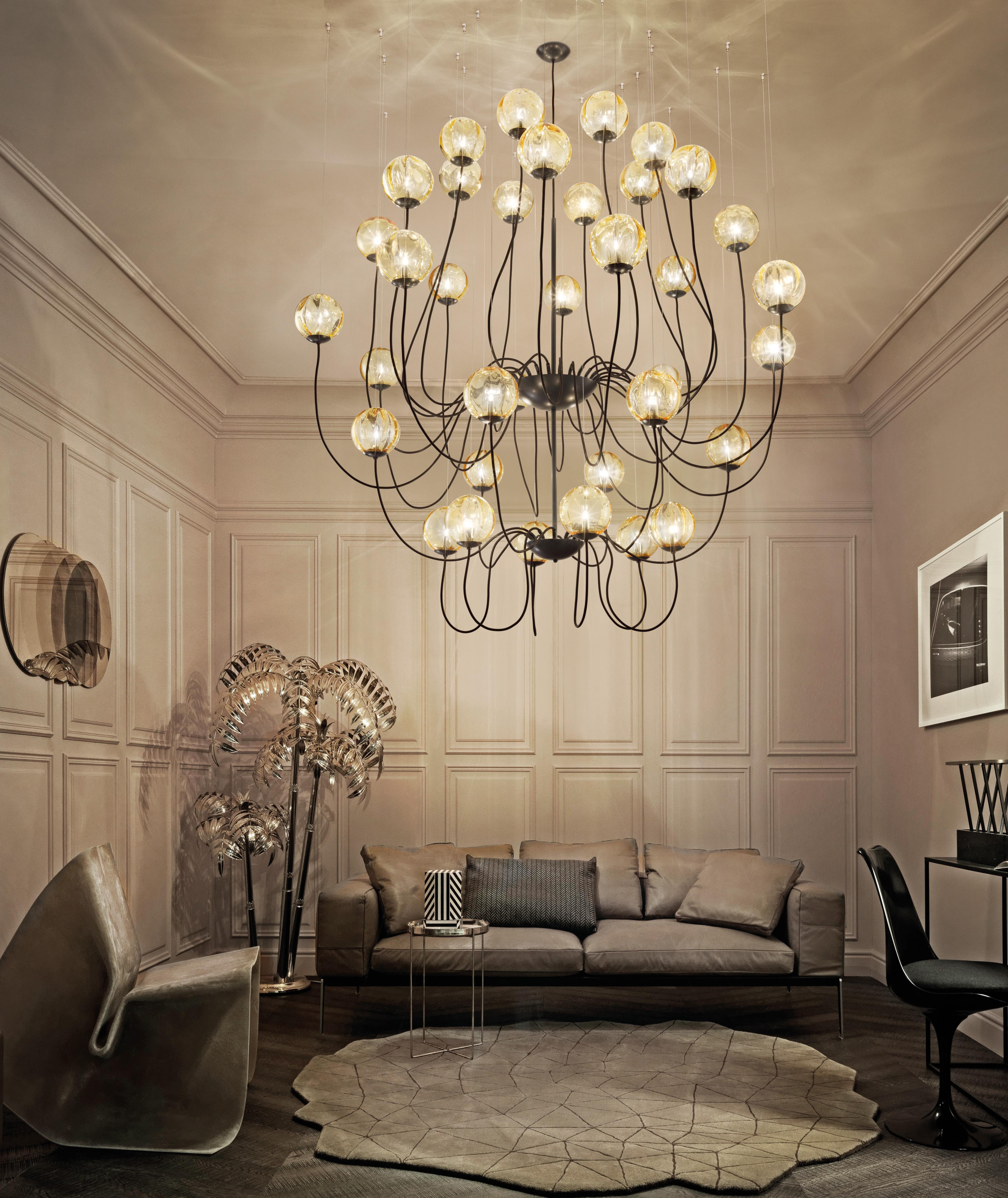 Collection of lamps with blown glass diffuser with an original irregularly lined ‘dégradé’ finish. The arms of the chandelier are hung individually to customer demand.

Light source: 
36x25W G9.
 