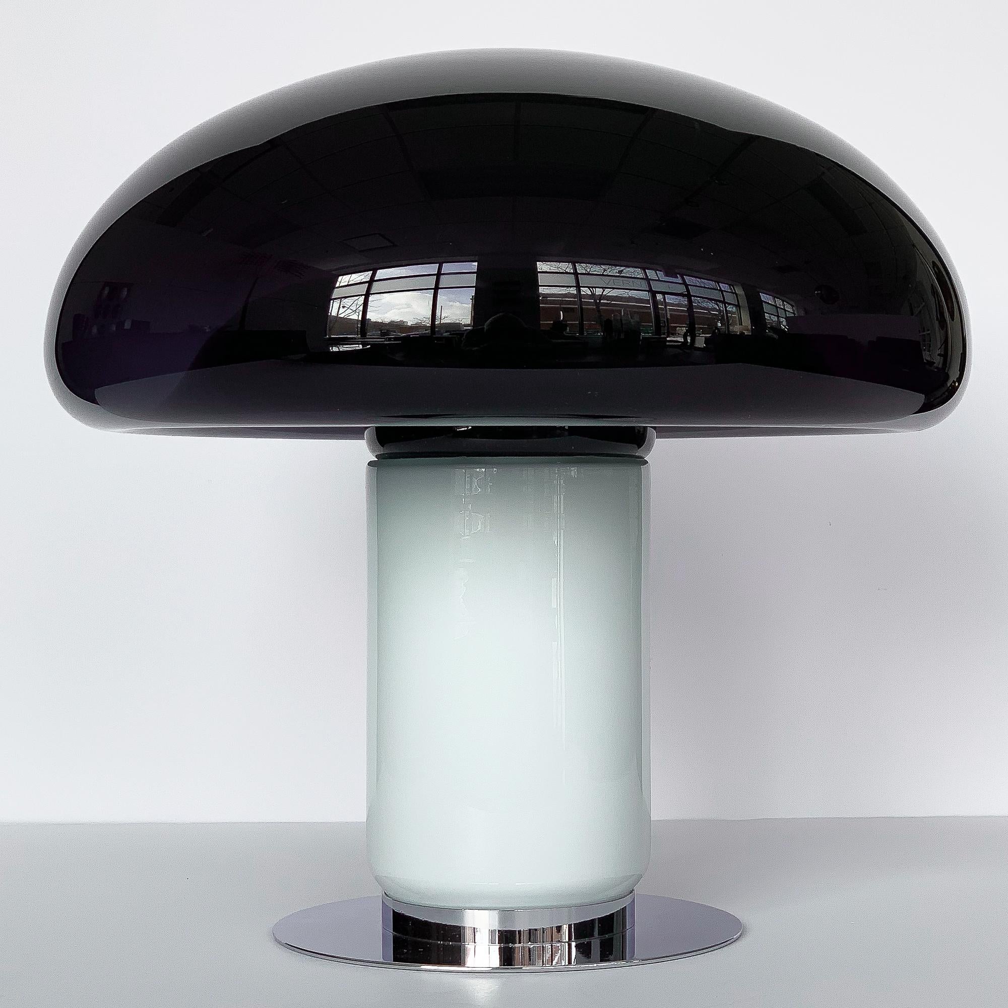 A Vistosi purple / amethyst mushroom shaped table lamp, circa 1960s Italy. Attributed to designer Michael Red. An almost black amethyst glass mushroom dome with fused white translucent stem. When the light is off the amethyst glass appears to be