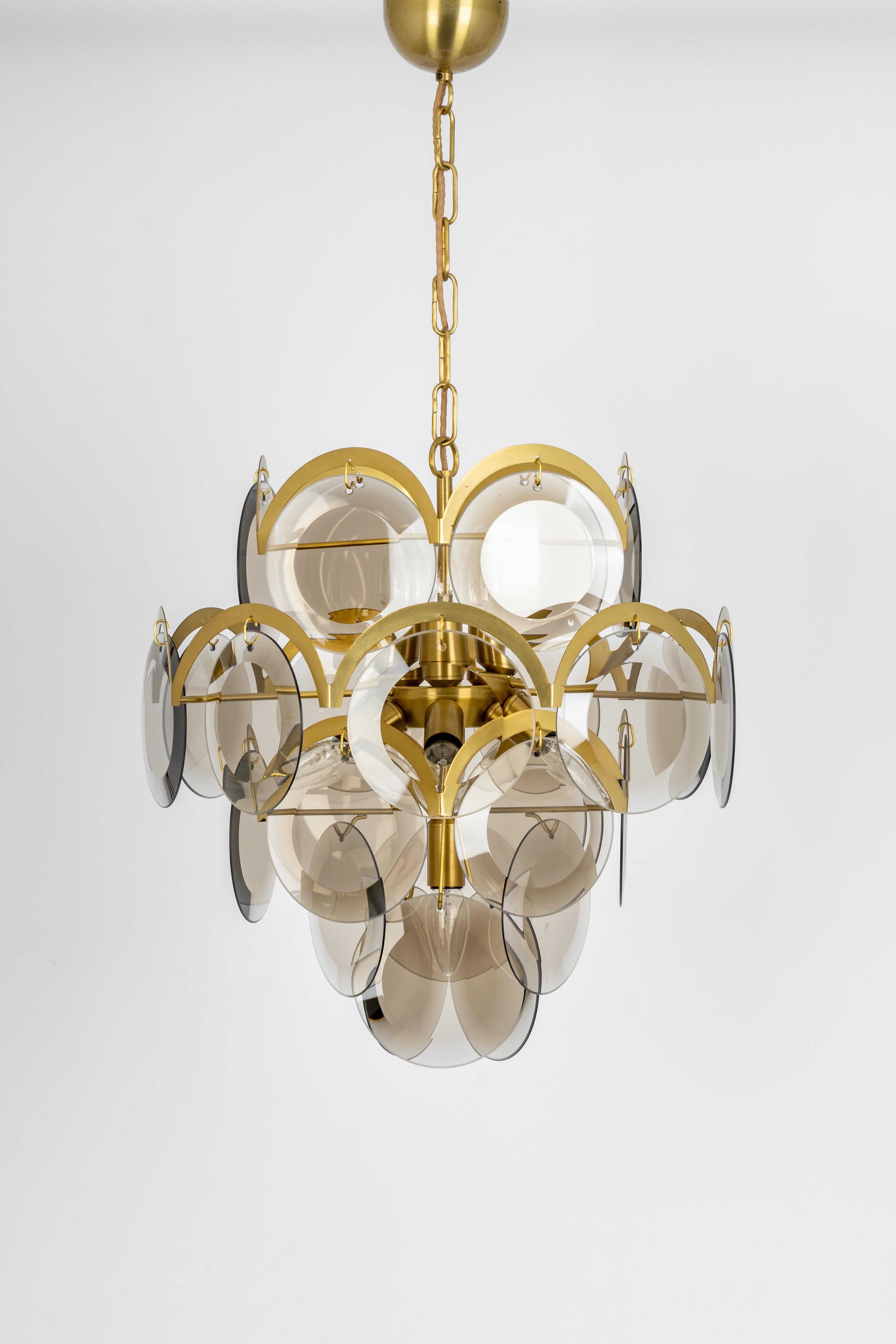 A stunning five-tier chandelier by Vistosi, Italy, manufactured in, circa 1960-1969
High quality and in very good condition. Cleaned, well-wired and ready to use. 
The fixture requires 10 x E14 small bulbs with 40W max each 
Light bulbs are not
