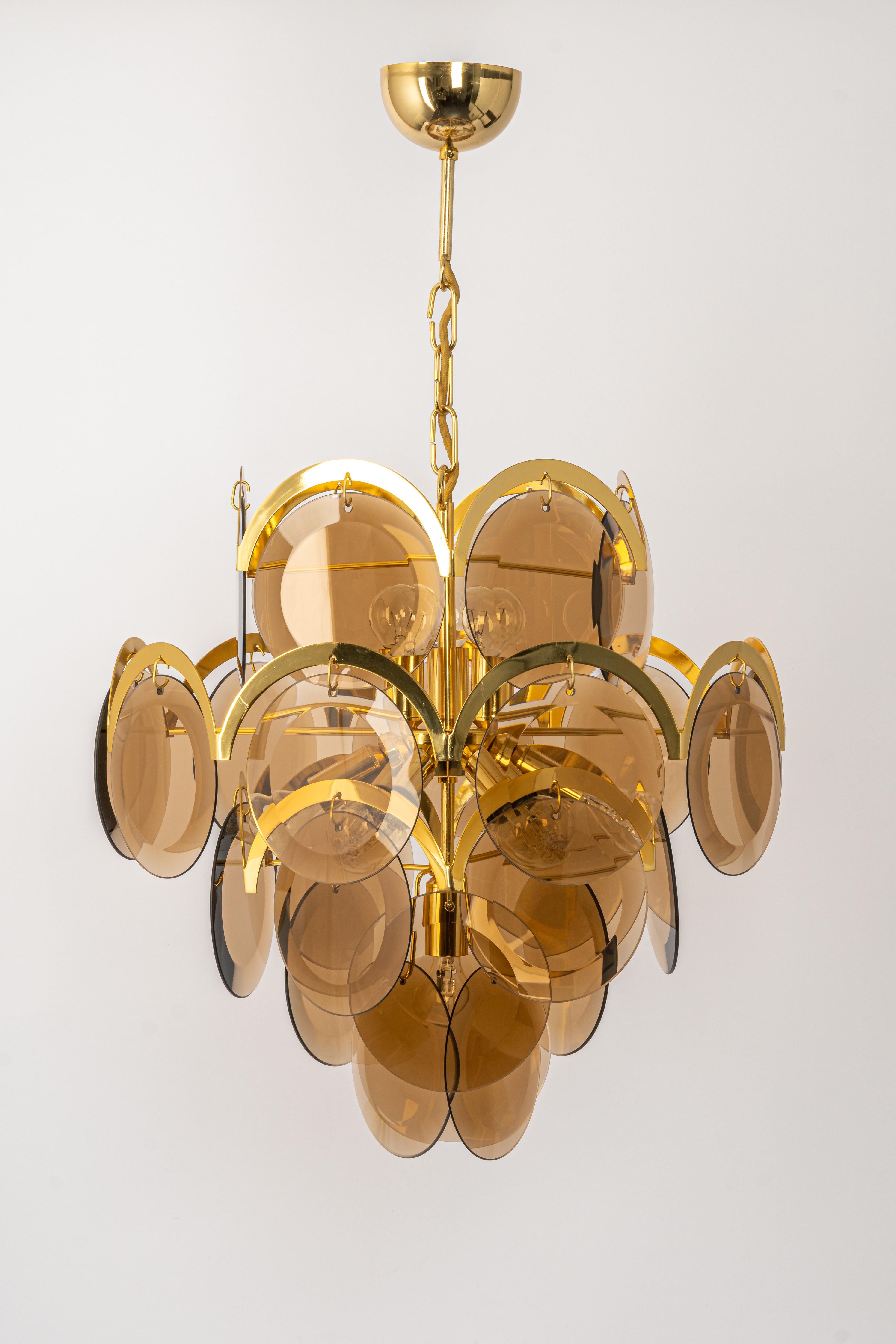 A stunning five-tier chandelier by Vistosi, Italy, manufactured in, circa 1960-1969
High quality and in very good condition. Cleaned, well-wired and ready to use. 
The fixture requires 10 x E14 standard bulbs with 40W max each 
Light bulbs are