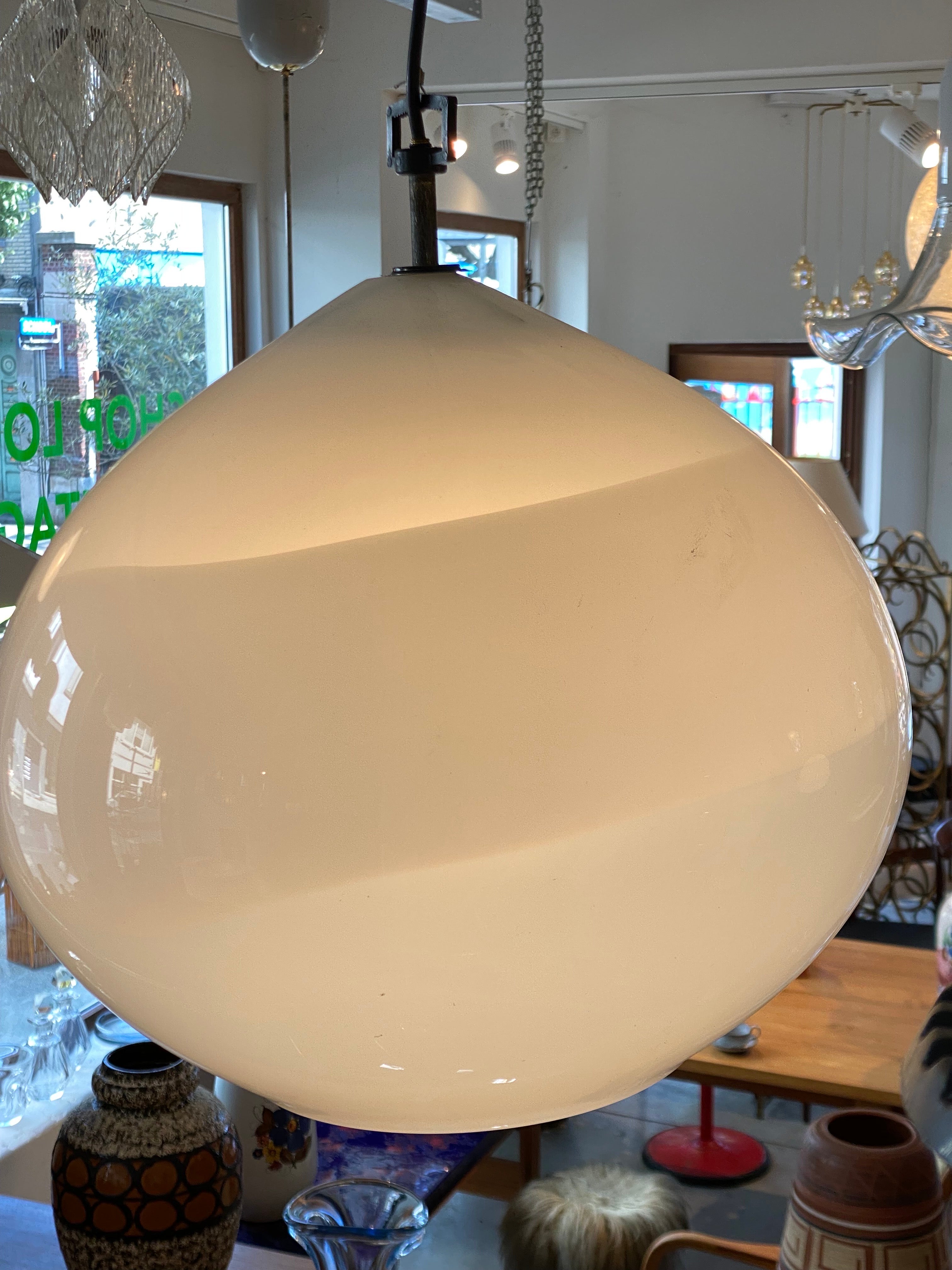 White opaline glass Italian pendant lamp oval shaped with opal swirl what features a diffused light and because of the open glass bottom a beam of light of one E27 Bulb on your table top or open space without seeing into the bulb.