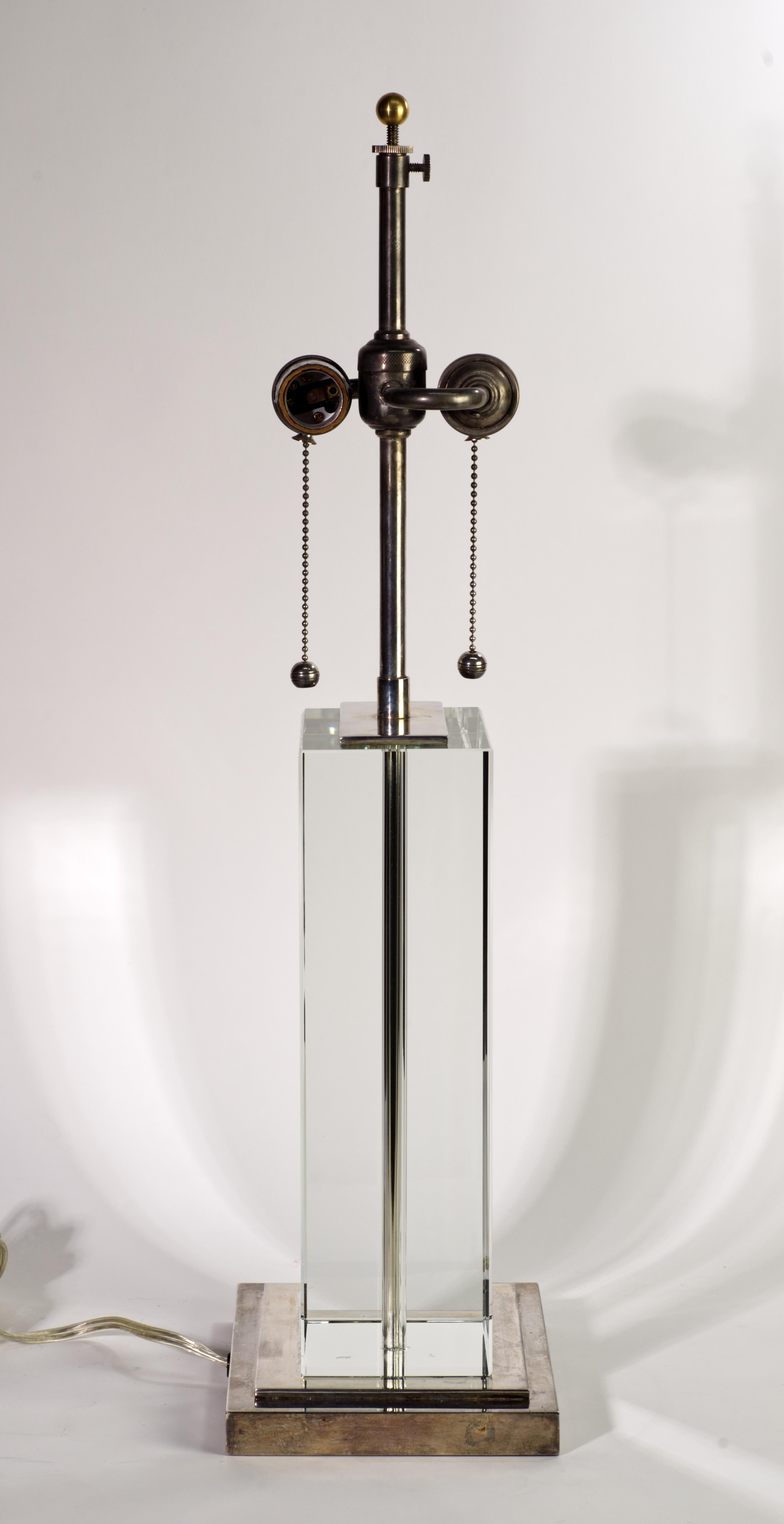 Classical design by Visual Comfort. 
The lamp is created from a rectangular block of ultra low iron glass that has been polished to perfection. Base plates and upper plate are nickeled metal.  Lovely patina present. Sockets are solid brass, also