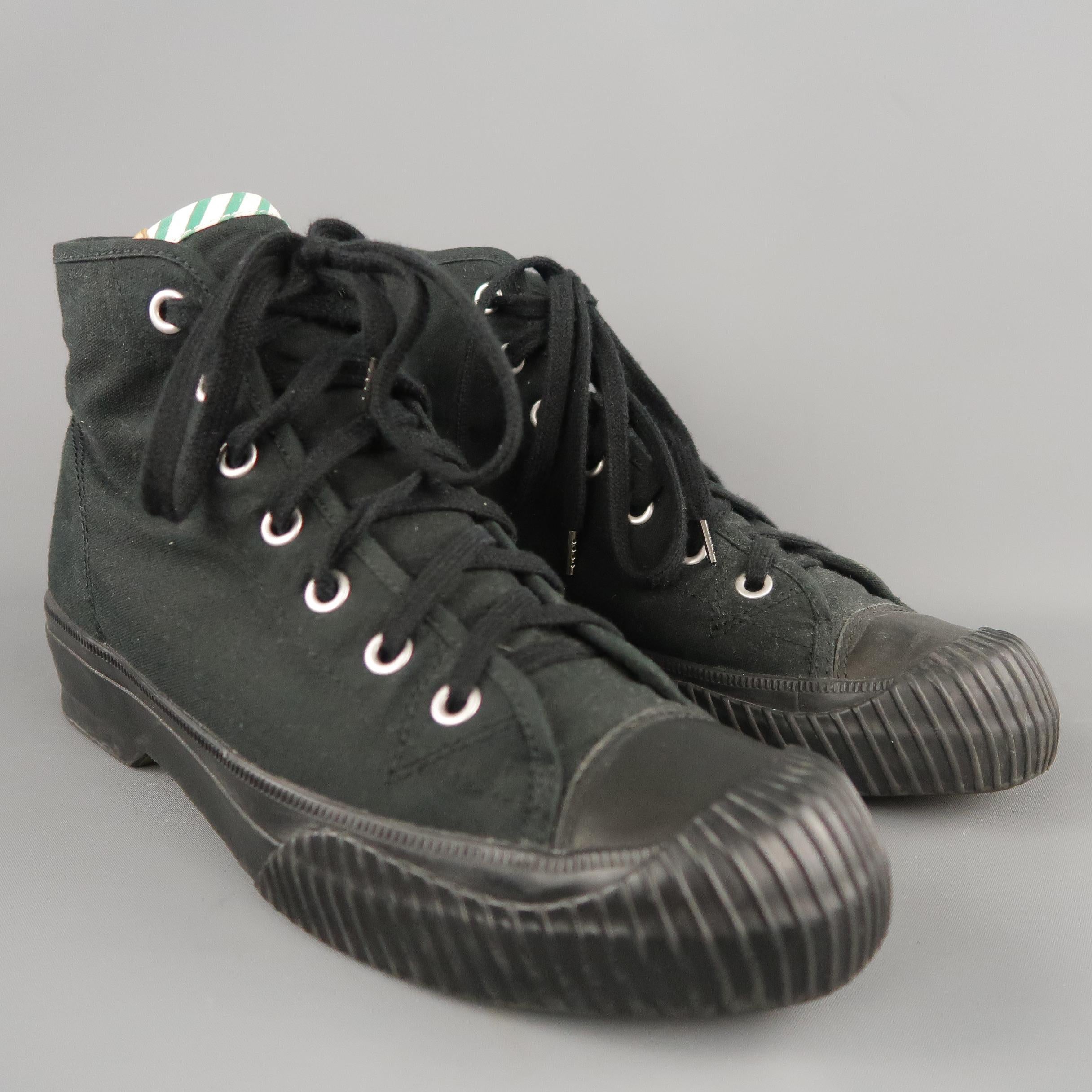 VISVIM sneaker boots come in black canvas with a striped trim tongue, silver tone grommet lace up front, and thick textured rubber sole.
 
Excellent Pre-Owned Condition.
Marked:10
 
Outsole: 12 x 4 in.