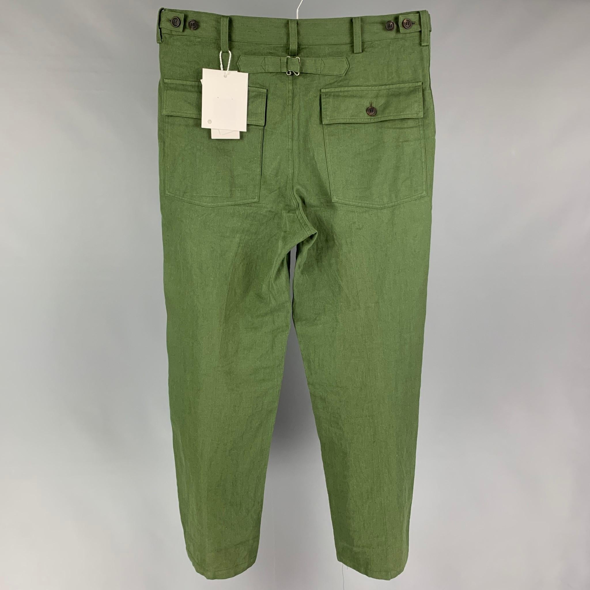 VISVIM 'Alda Pants' comes in a olive linen featuring a pressed finish, adjustable waistband, original water buffalo horn buttons, two side pockets, back strap, and a button fly closure. Made in Japan. 

New With Tags. 
Marked: JP 4
Original Retail