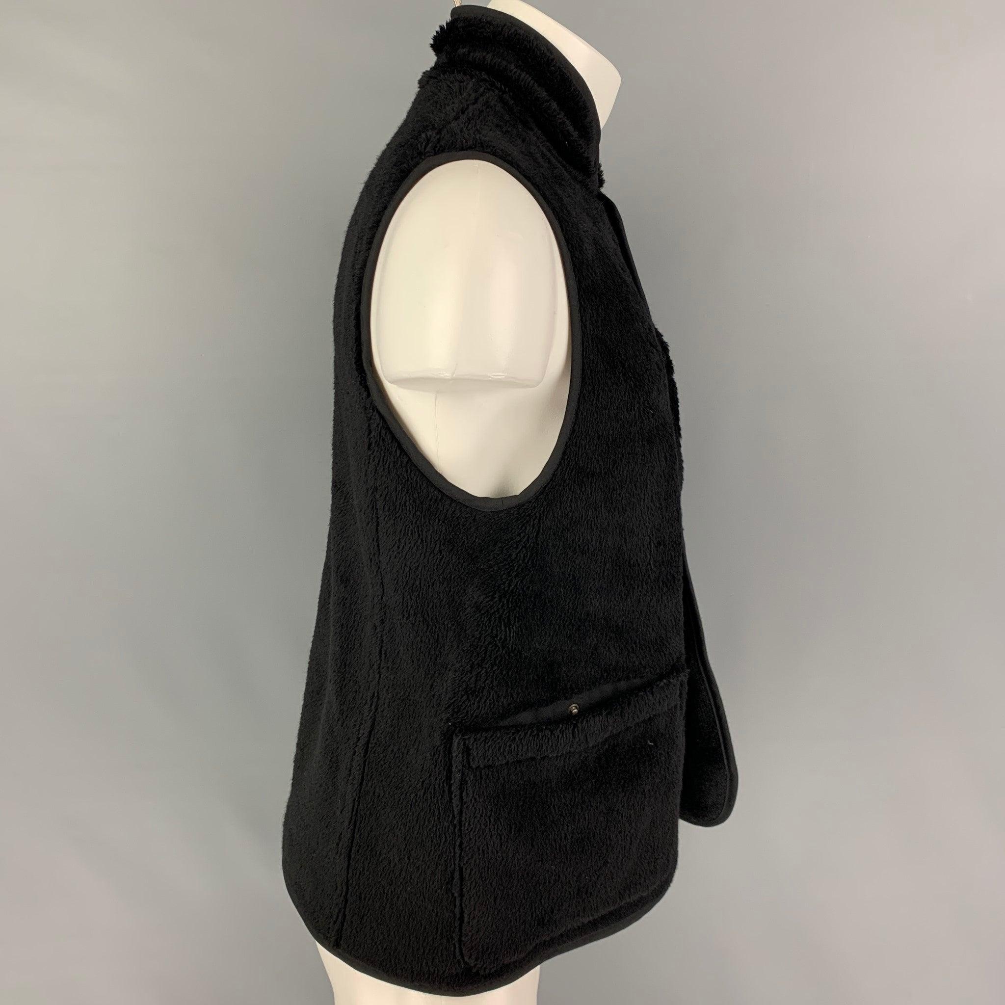 VISVIM SPORT vest comes in a black textured boa-fleece wool featuring a reversible style, patch pockets, stand collar, and a buttoned closure. Made in Japan.
Very Good
Pre-Owned Condition. Fabric tag removed.  

Marked:   3 

Measurements: 
