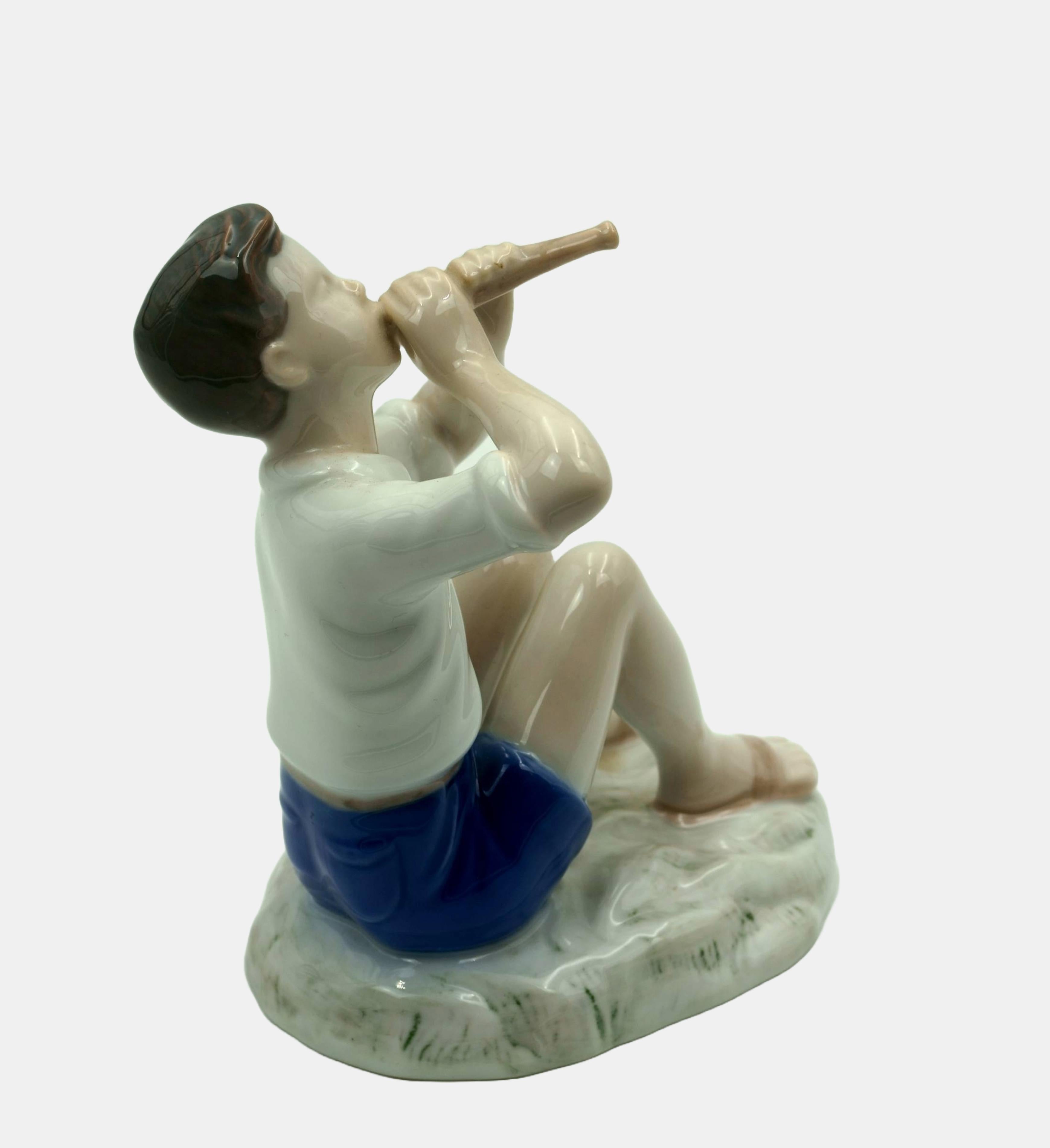 Vita Birgitte Thymann, Boy playing the flute, between 1952 and 1957. model number 2344. First choice. Porcelain with underglaze painting. 13 cm (height) x 11 cm (length) x 12 cm (depth). Marked and numbered under the base.

- in perfect condition 