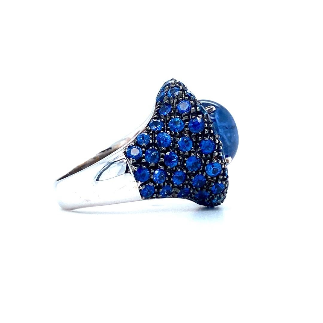 18K white gold elegant ring is from our Ocean Treasures Collection. This piece of jewellery has beautiful cabochon blue sapphire in total of 3.88 decorated by blue sapphire pave in total of 4.10 Carat. Total metal weight is 12.9 Carat. 

Ocean